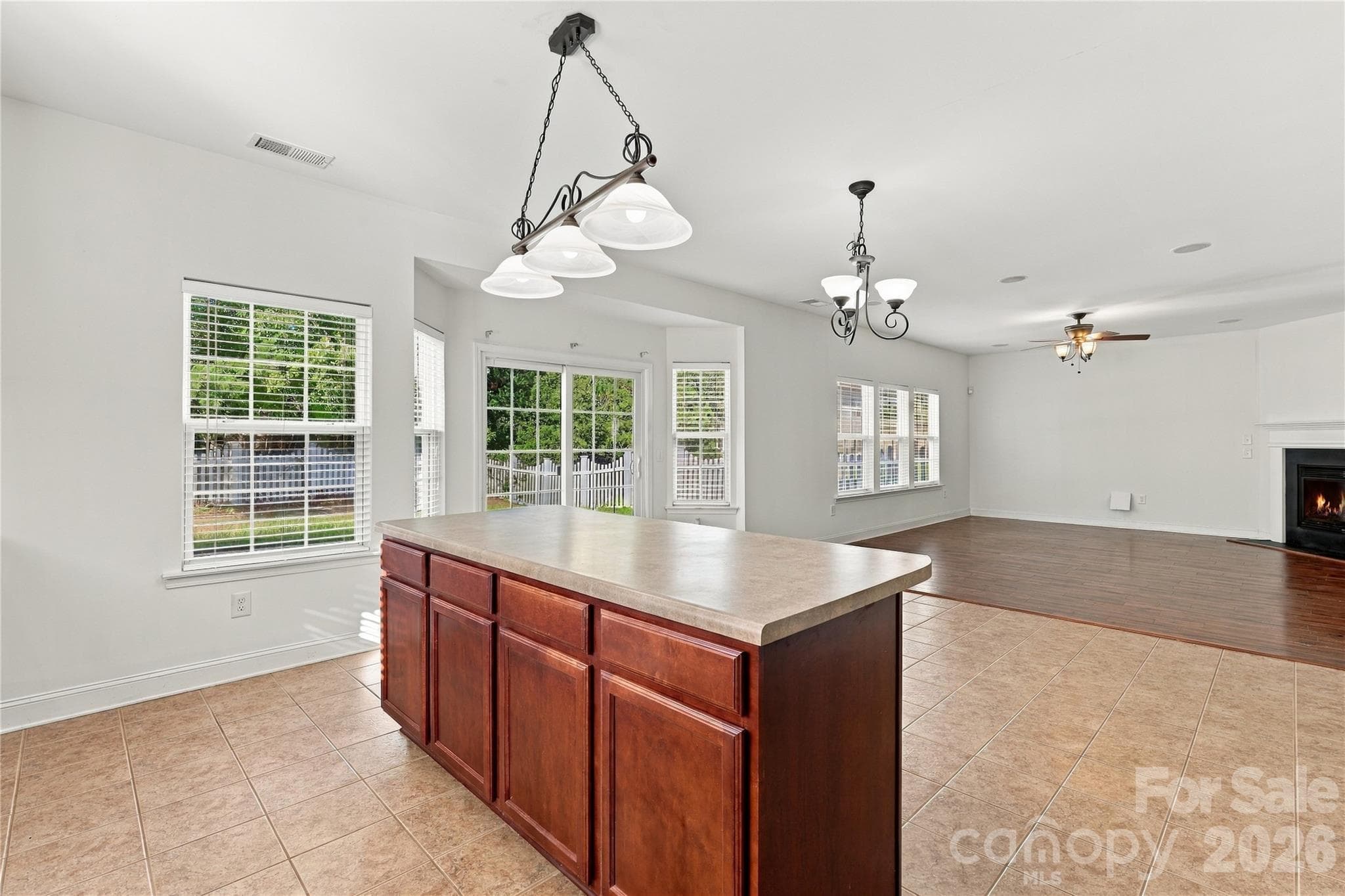 A spacious island and wraparound windows fill the kitchen with natural light. - 327 Annaberg Lane, Monroe