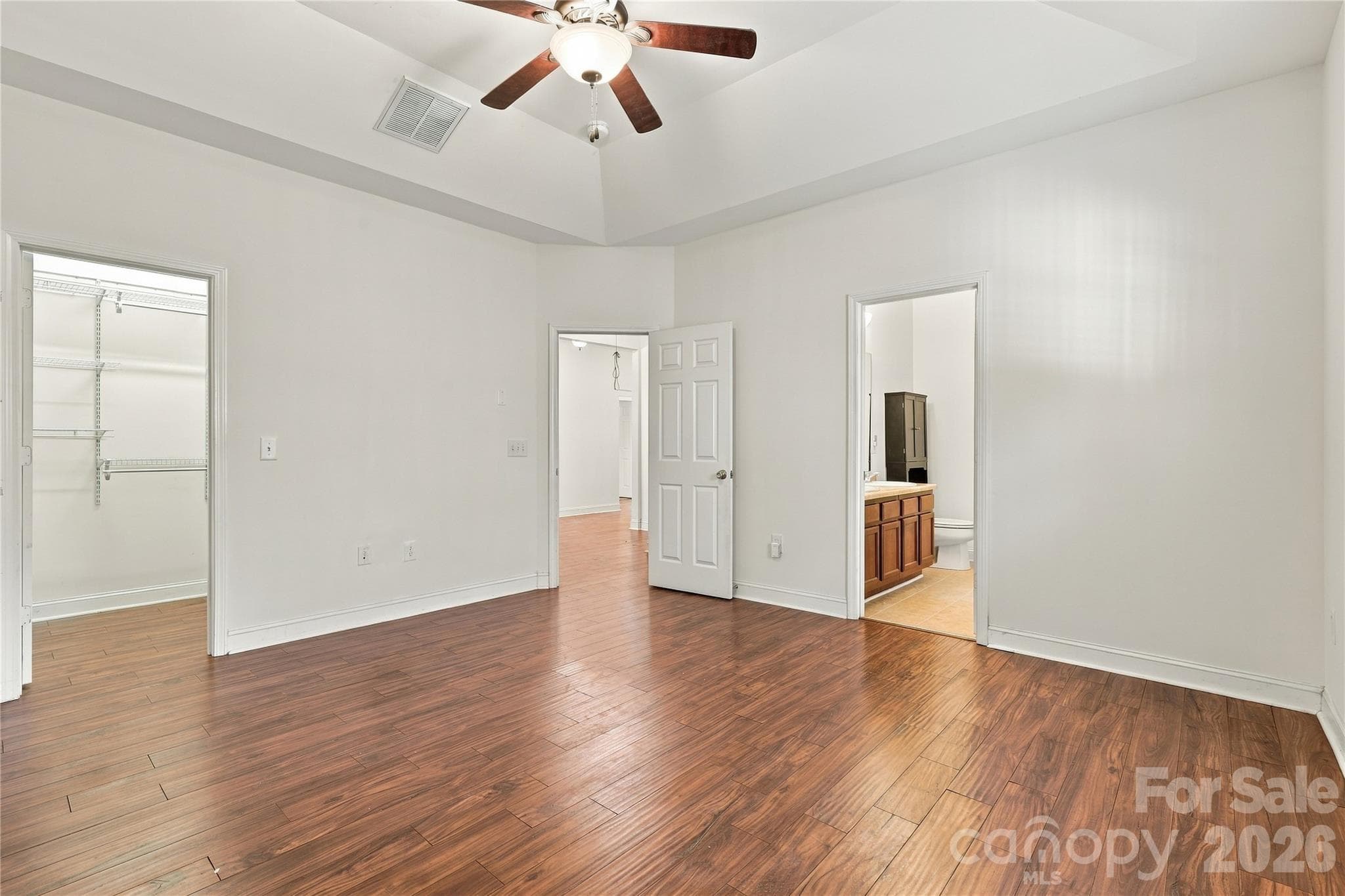 The spacious primary bedroom connects to the private bath and walk-in closet. - 327 Annaberg Lane, Monroe