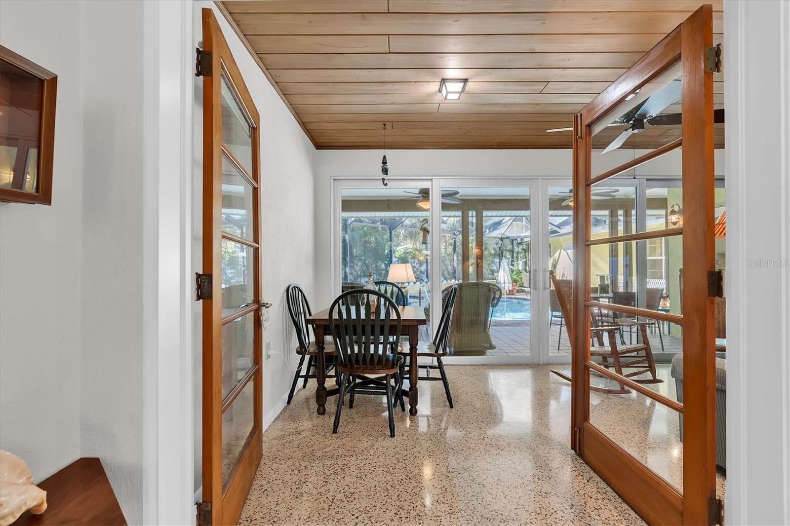 French doors open to Florida room provides extra dining and seating space overlooking the pool and spa. - 7106 PALM DR, HOLMES BEACH