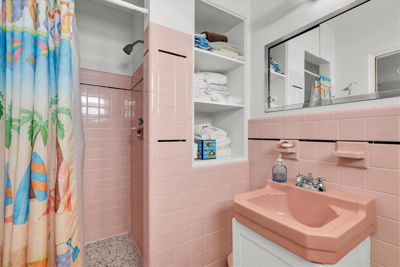 The pink bath is an en-suite for the second bedroom. - 7106 PALM DR, HOLMES BEACH