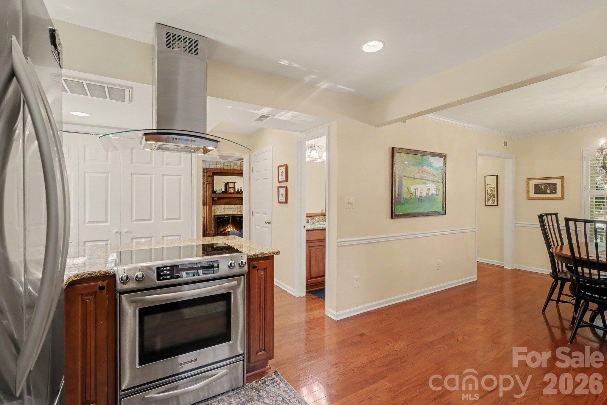 Updated stainless steel appliances. Hallway shows half bathroom and pantry as you move into the living room. - 640 Heather Lane, Charlotte