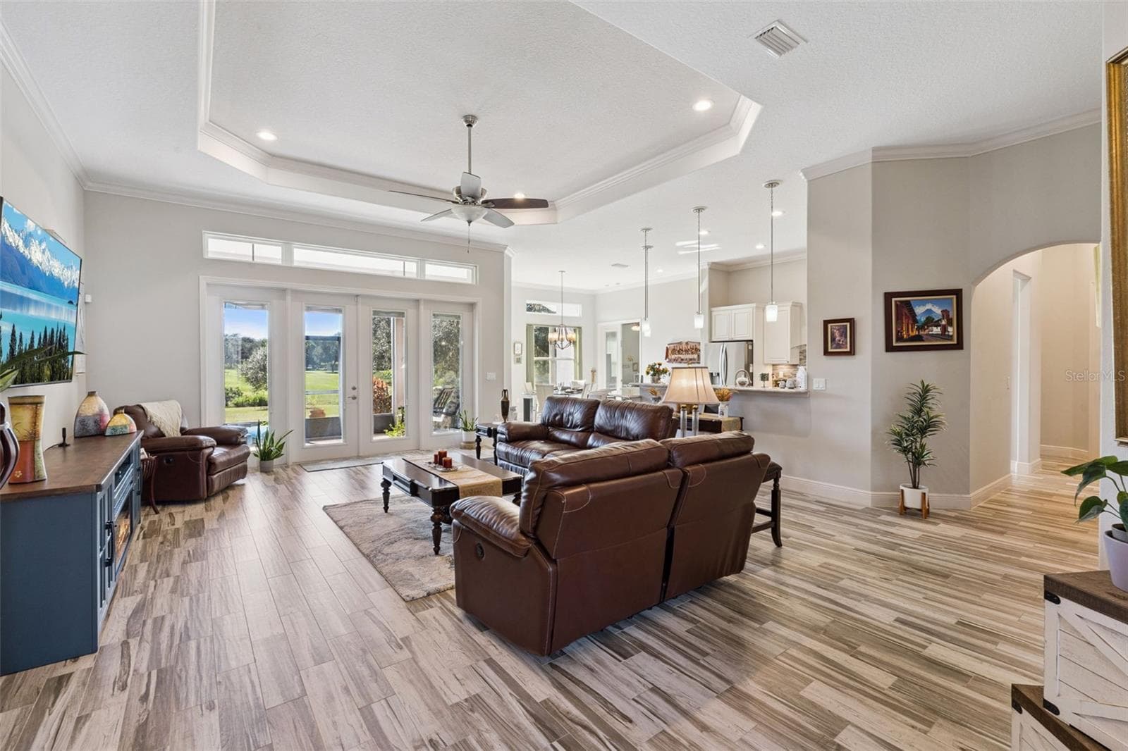 Welcome guests through the front double door into the open floor plan with family room with a beautiful water view - 36819 WOLF CT, EUSTIS