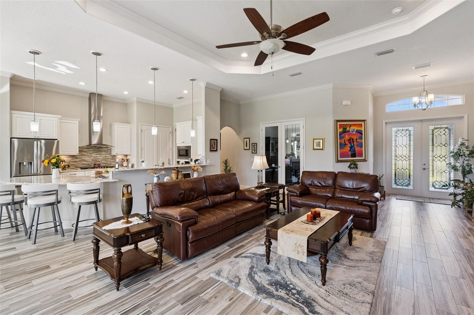 Beautifully updated kitchen featuring an expansive breakfast bar with seating for eight, seamlessly overlooking the spacious family room. - 36819 WOLF CT, EUSTIS