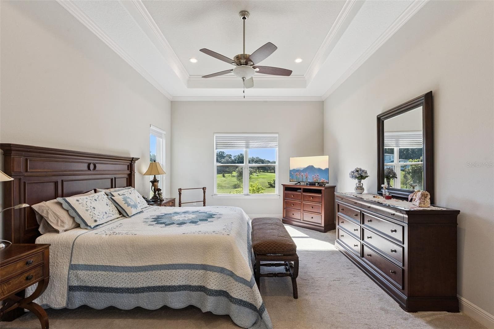 Private primary suite featuring a serene, expansive water view that brings tranquility into the living space. - 36819 WOLF CT, EUSTIS