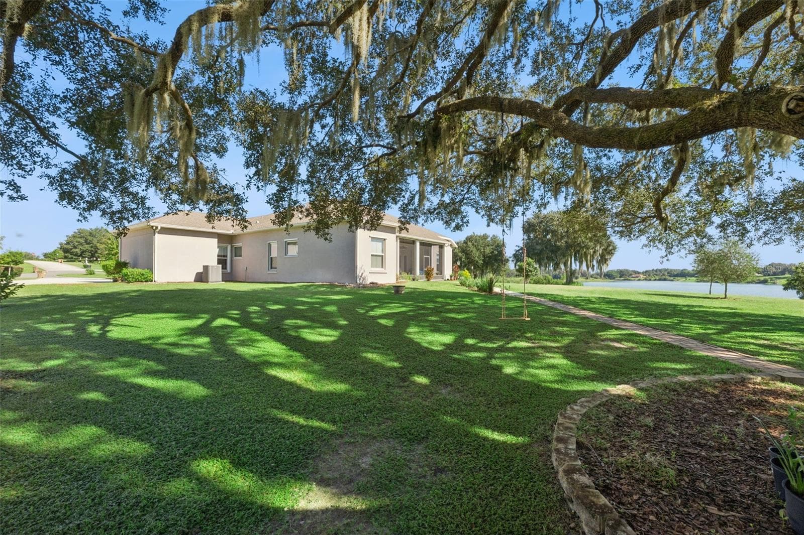 Exterior rear/side view with water view in the distance - 36819 WOLF CT, EUSTIS