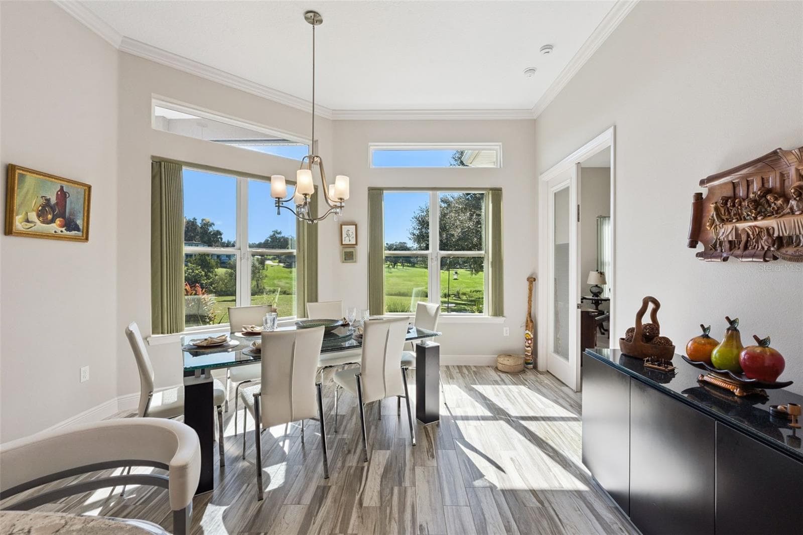 Enjoy expansive views with transom windows, complemented by a light, neutral paint palette that enhances the bright and airy atmosphere. - 36819 WOLF CT, EUSTIS