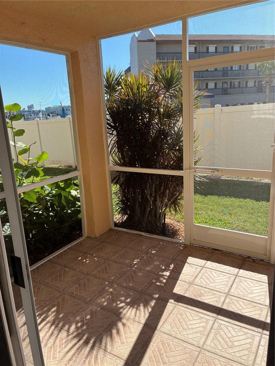 Screened in porch near parking - 8901 BLIND PASS RD #127, ST PETE BEACH