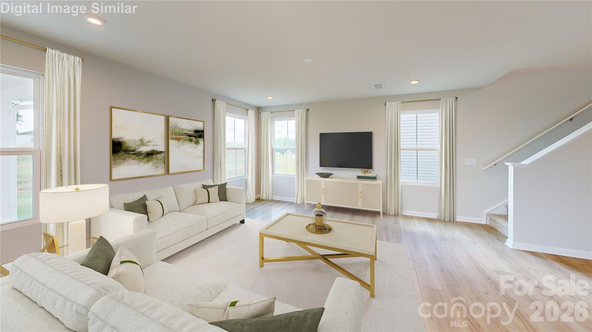 This spacious great room is filled with natural light and perfect for gatherings. Its open-concept layout keeps everyone connected—whether you're relaxing or chatting from the kitchen, the conversation flows effortlessly. - 833 E Liberty Street, China Grove