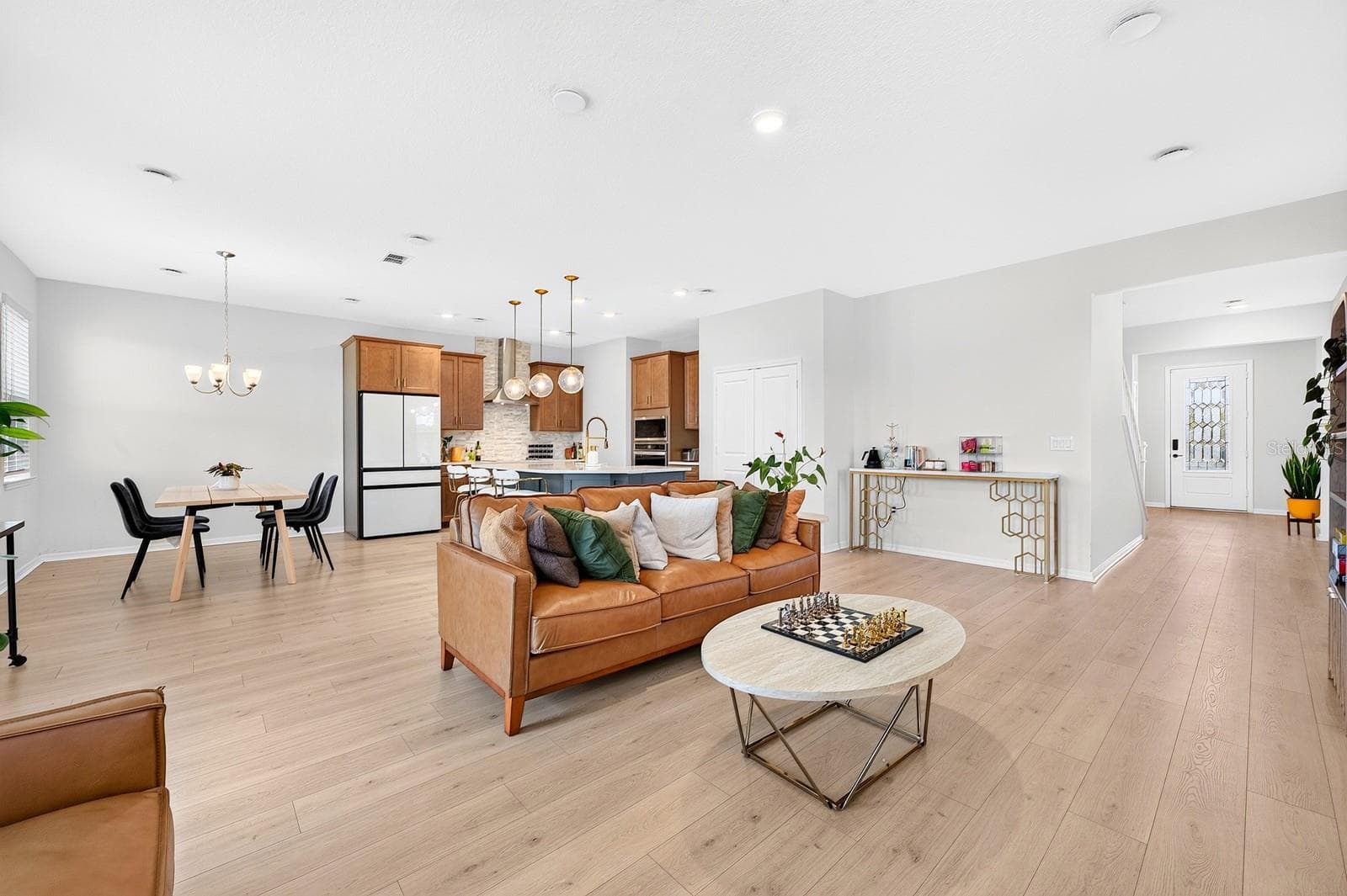The OPEN-CONCEPT FLOOR PLAN seamlessly connects the Living Room, Dining Room and Kitchen, creating an ideal setting for everyday living and entertaining. - 1785 PETIOLE PL, KISSIMMEE