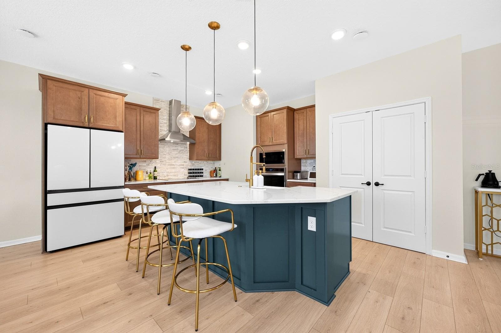 The Kitchen island includes space for counter-height seating. - 1785 PETIOLE PL, KISSIMMEE