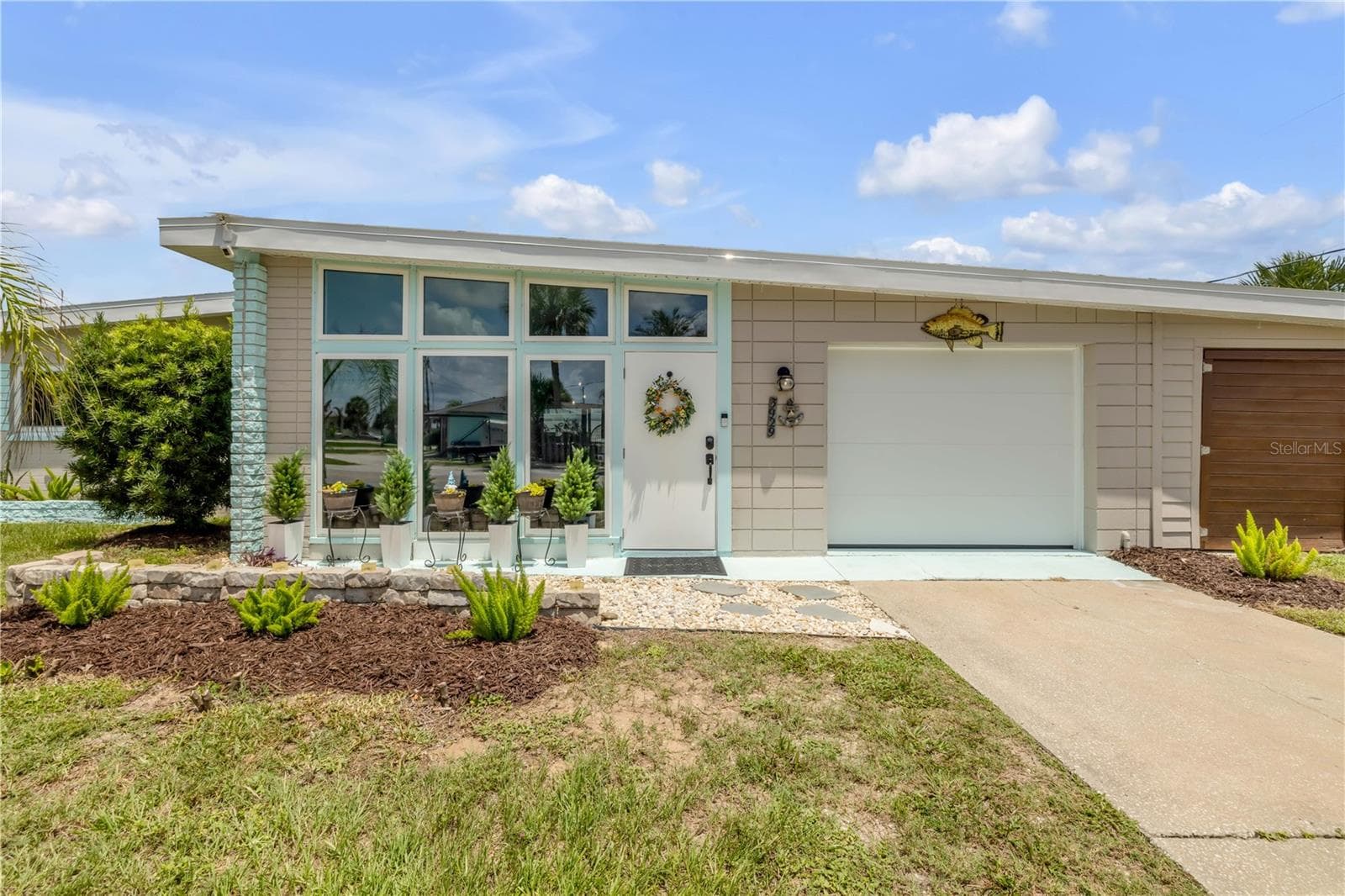Front entry with enclosed porch and attached garage. - 3929 S PENINSULA DR, PORT ORANGE