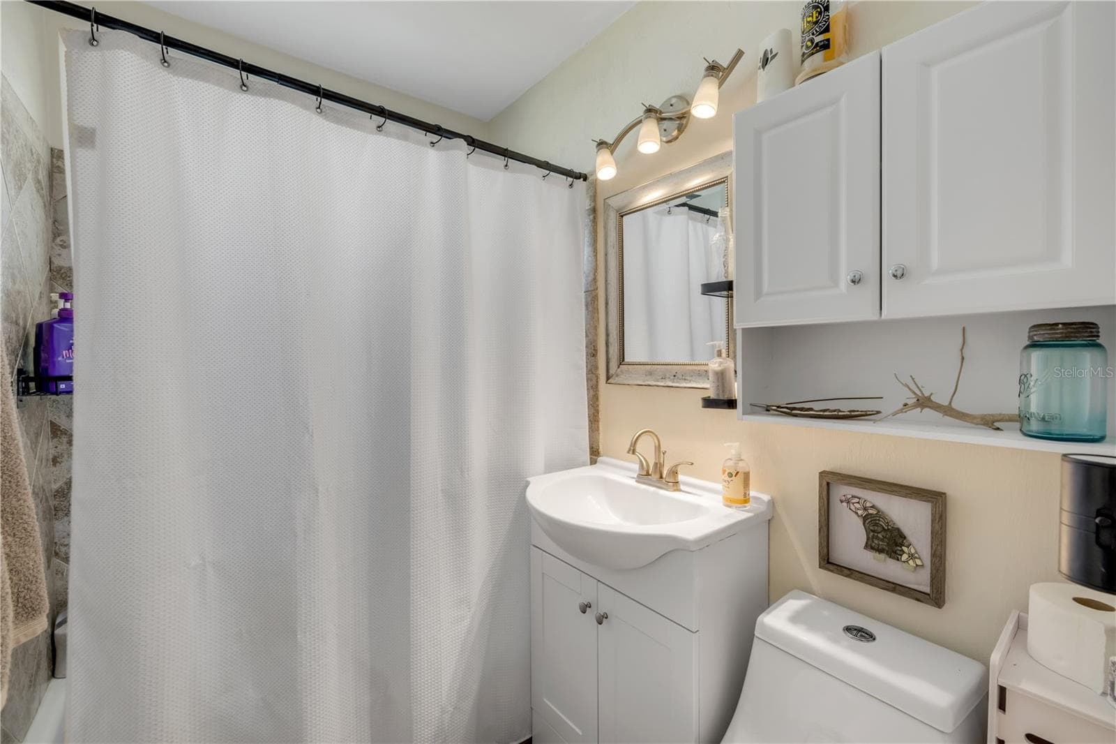 Bathroom with a vanity and tub/shower combination. - 3929 S PENINSULA DR, PORT ORANGE