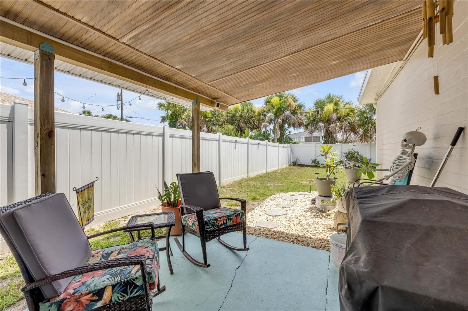 Alternate covered-patio view overlooking the fenced yard. - 3929 S PENINSULA DR, PORT ORANGE