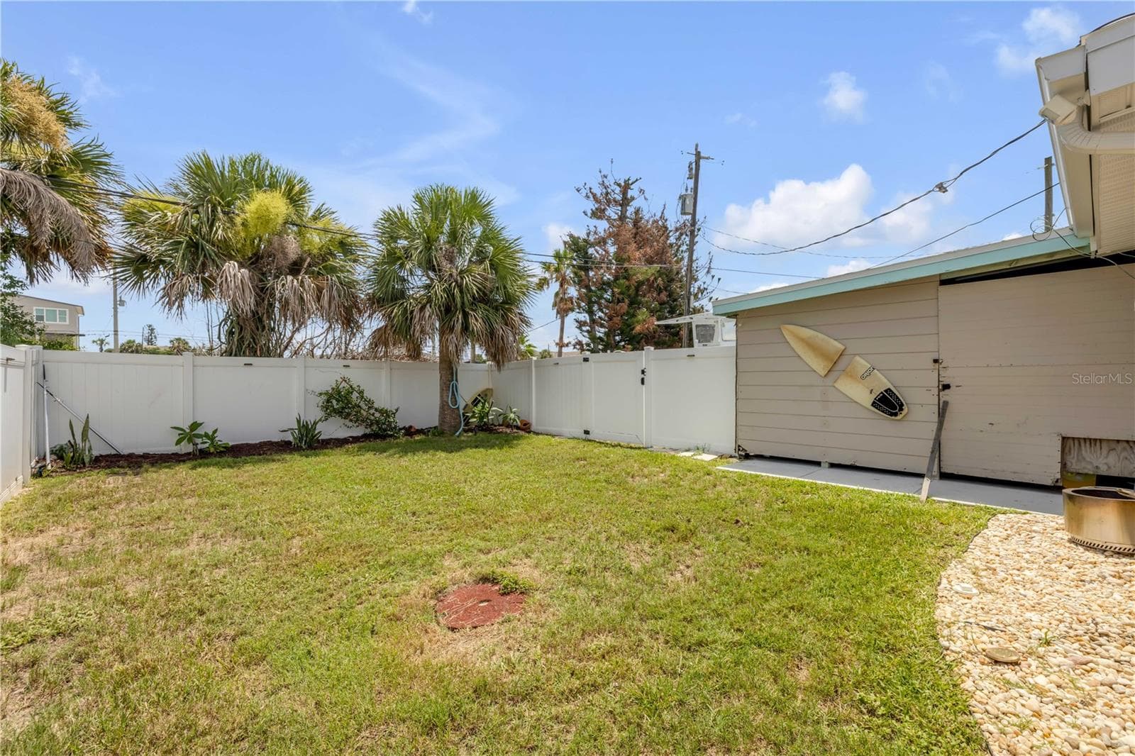 Fenced yard with lawn and detached outbuilding. - 3929 S PENINSULA DR, PORT ORANGE