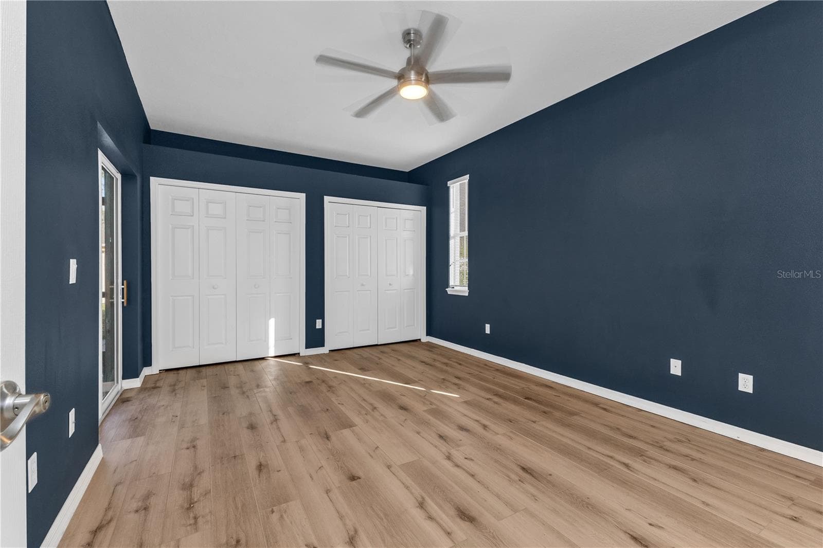 Primary bedroom dual closets and sliding glass doors to lanai. - 2739 ATWATER DR, NORTH PORT