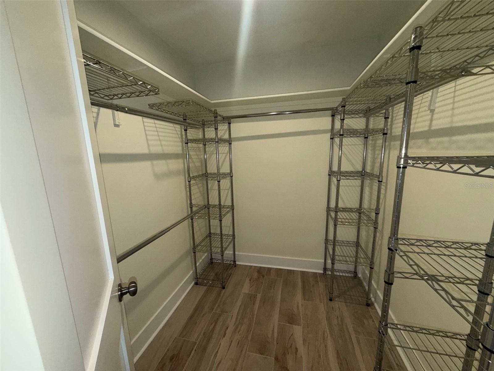 Walk-in closet in primary bedroom - 1874 WATEROAK DR W, CLEARWATER