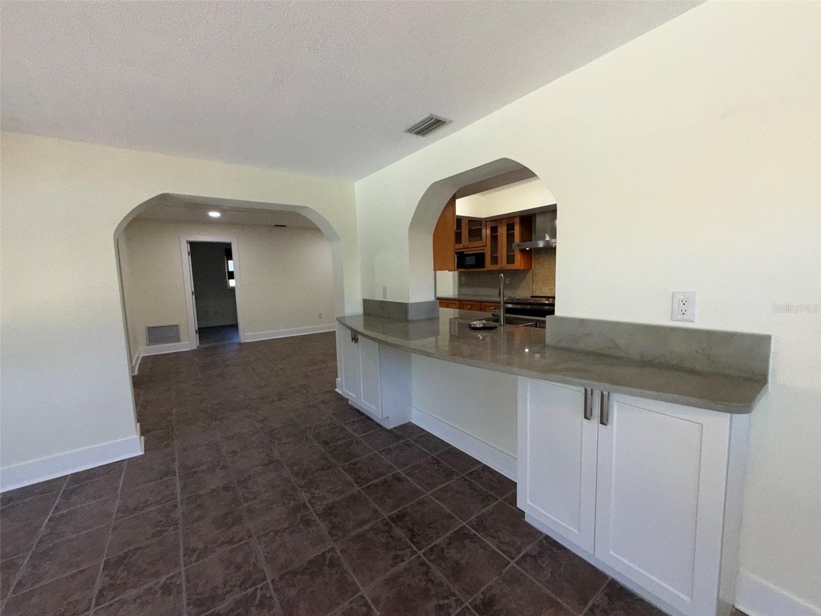 Rear Florida room with pass through from kitchen - 1874 WATEROAK DR W, CLEARWATER