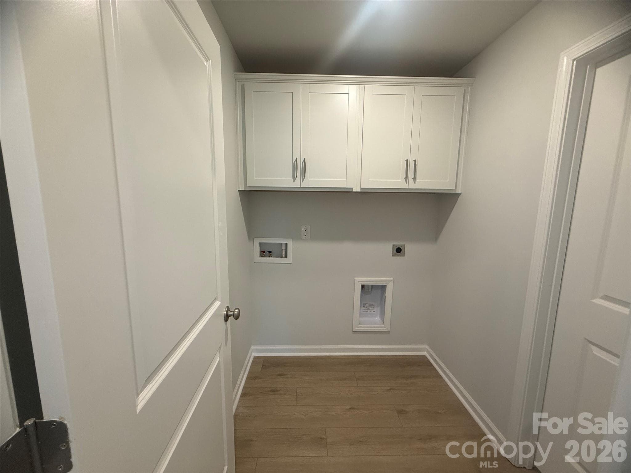 Laundry Room w/ built in cabinets located next to Primary Room - 1305 Bansal Drive, Charlotte