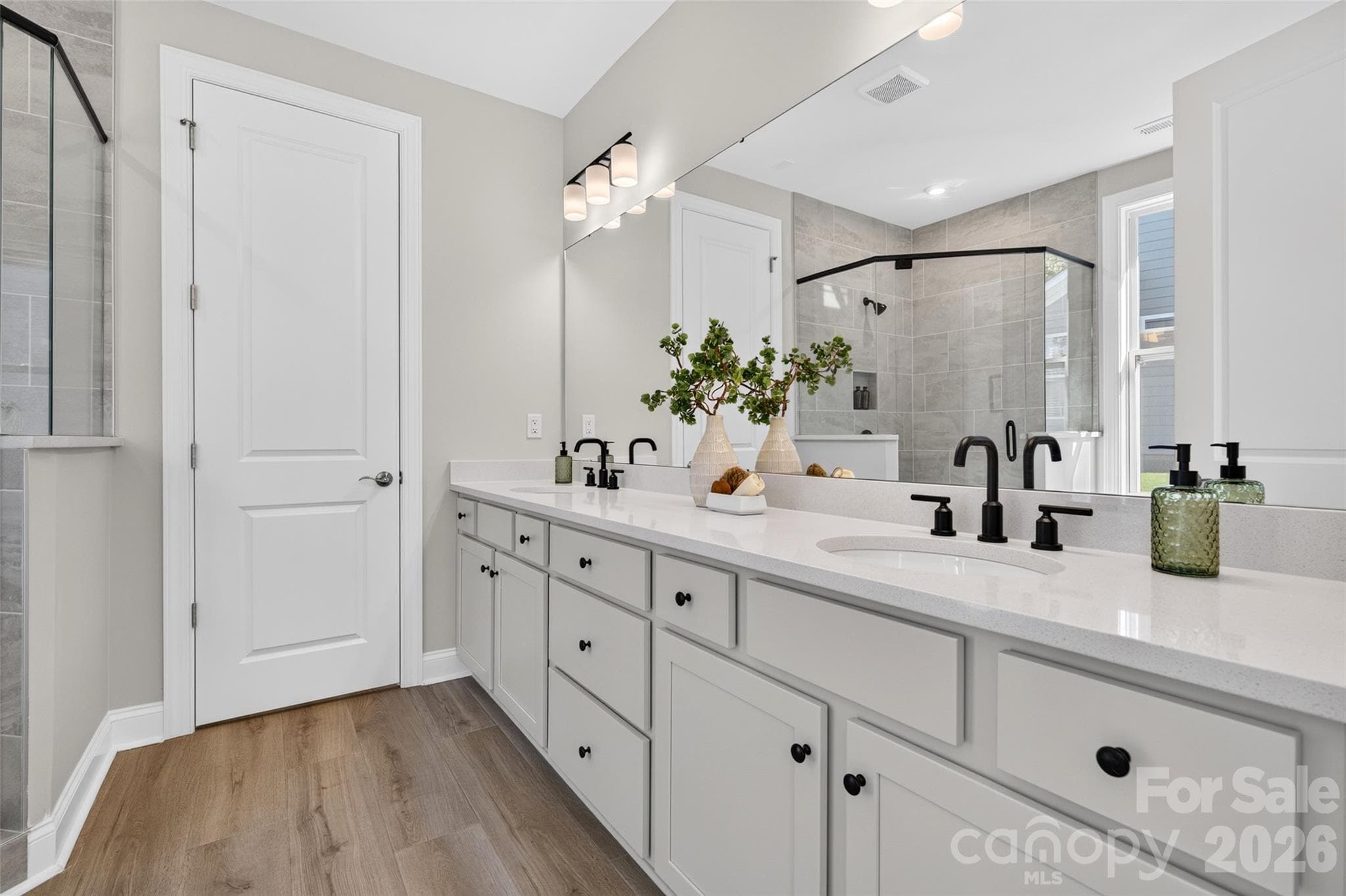 Primary ensuite bath with dual vanities - 8905 Silver Springs Court, Charlotte