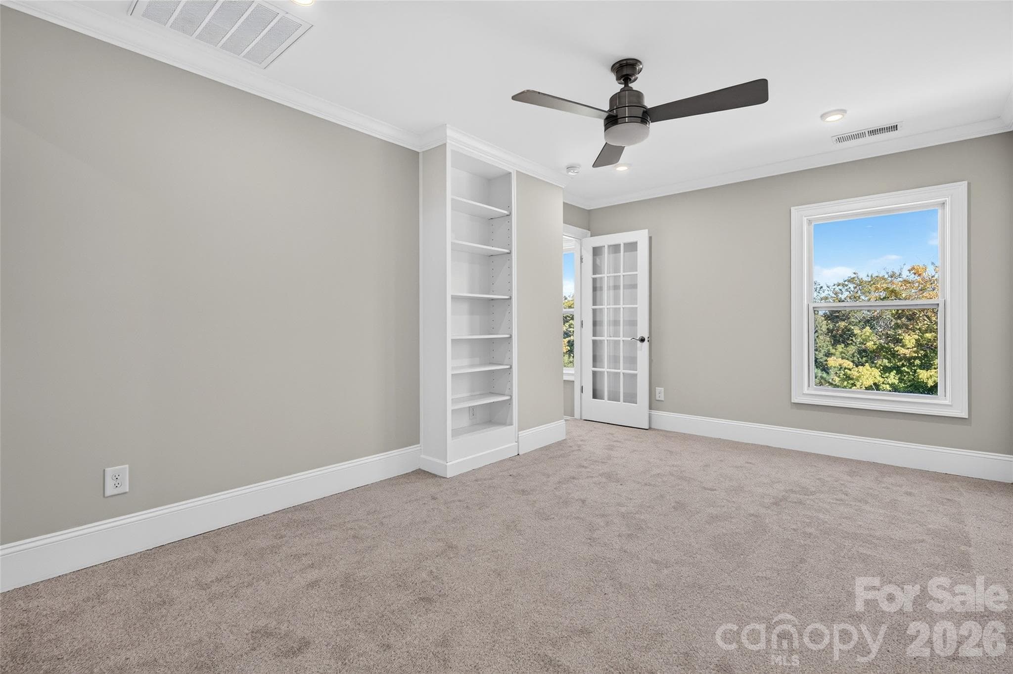 Upstairs Bonus/Bedroom with custom built-ins and 15-lite glass door - 8905 Silver Springs Court, Charlotte