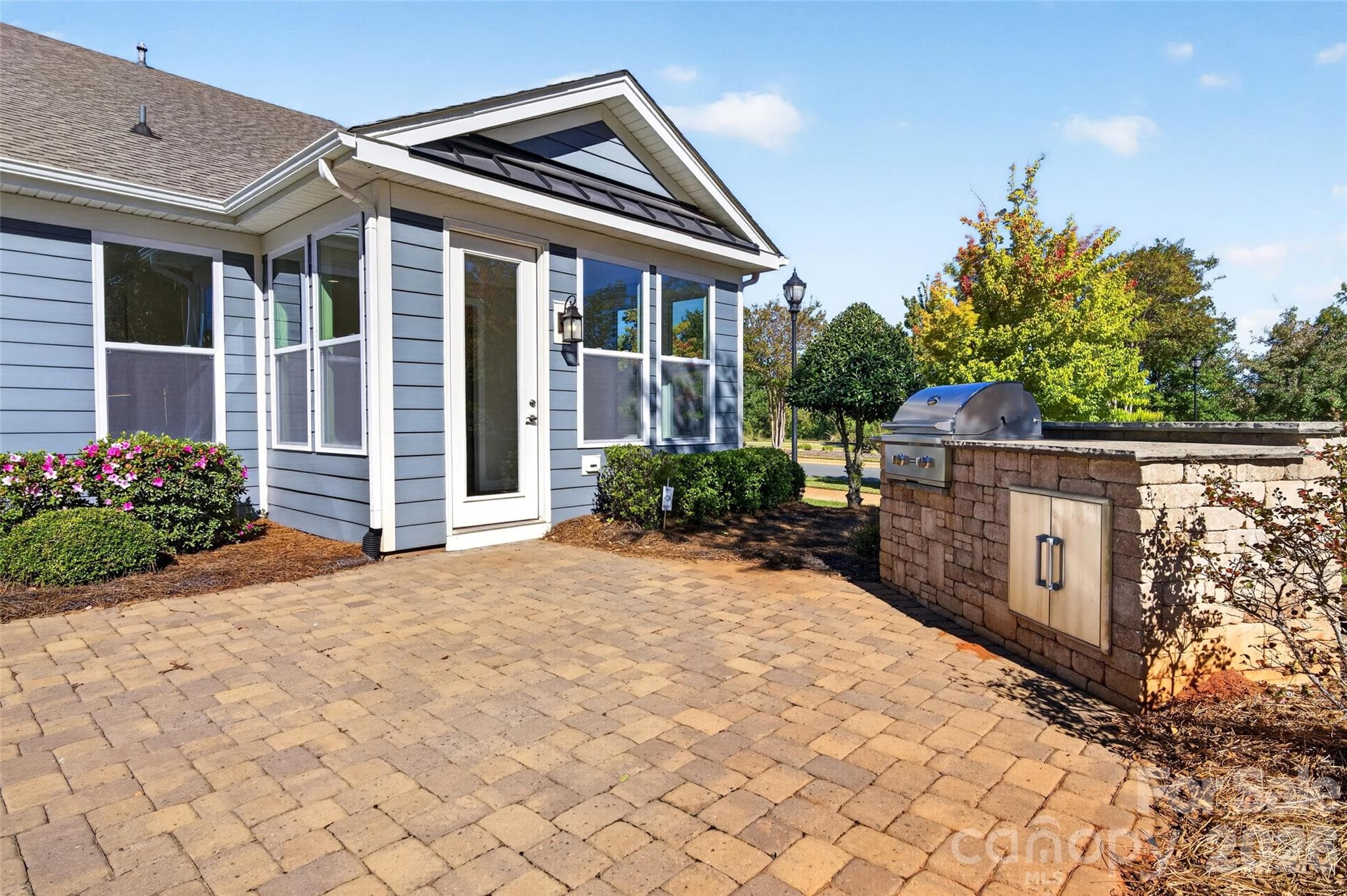 Custom paver rear patio with built-in grill and fireplace - 8905 Silver Springs Court, Charlotte