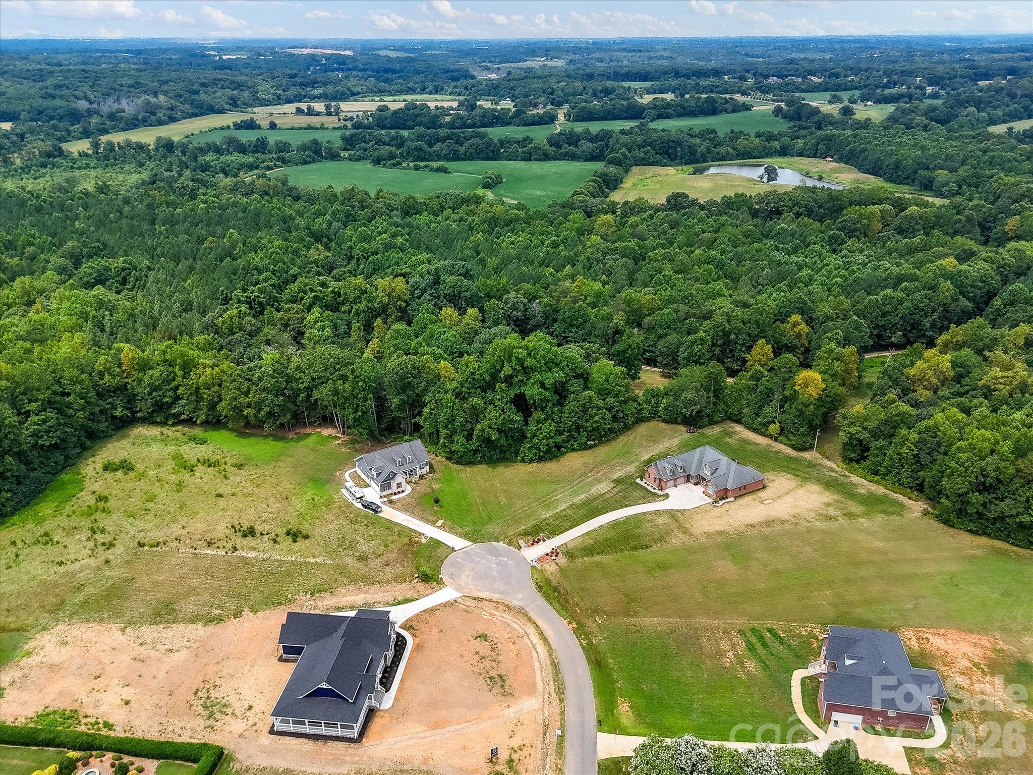 Stunning aerial view showcasing spacious homesites nestled along a peaceful cul-de-sac, surrounded by mature trees, picturesque countryside, and beautiful natural scenery. - Lot 15 Peacehaven Place, Statesville