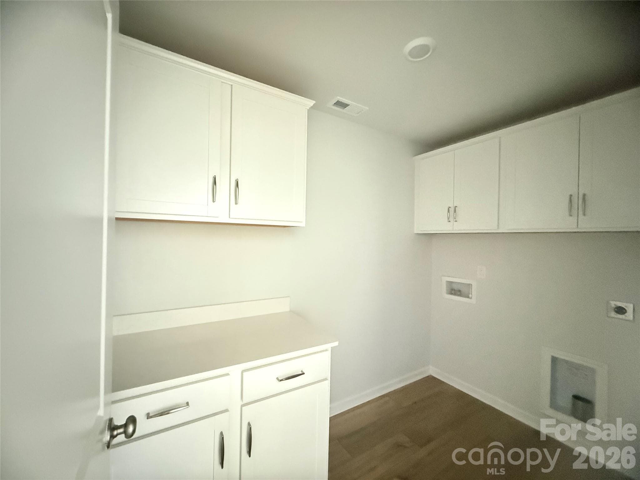 Laundry room with extra cabinet space and folding table - 1227 Bansal Drive, Charlotte