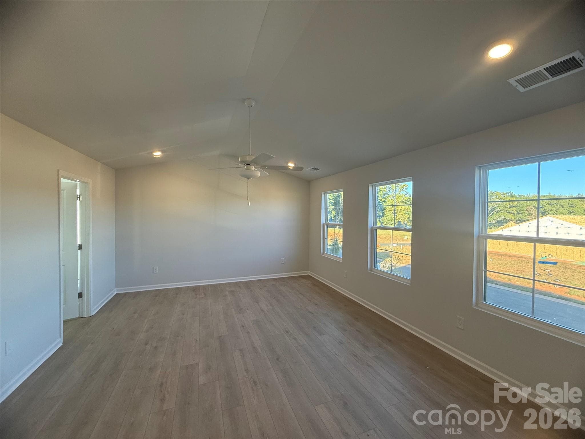 Large Primary Bedroom with vaulted ceilings and 3 windows allow for ample natural light - 4021 Juno Drive, Charlotte