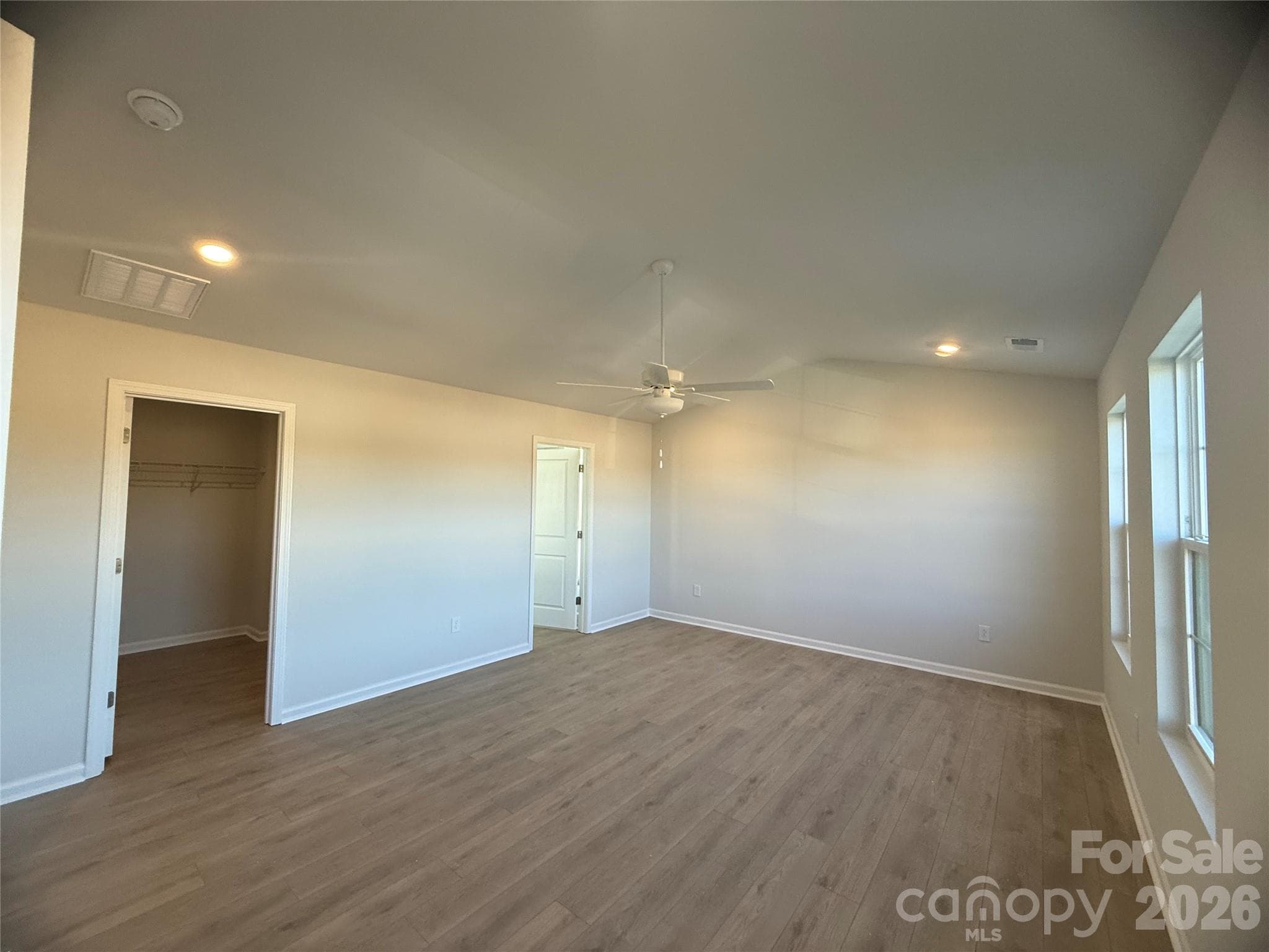 Primary bedroom leading into large walk-in closet & a second door for full ensuite bathroom - 4021 Juno Drive, Charlotte