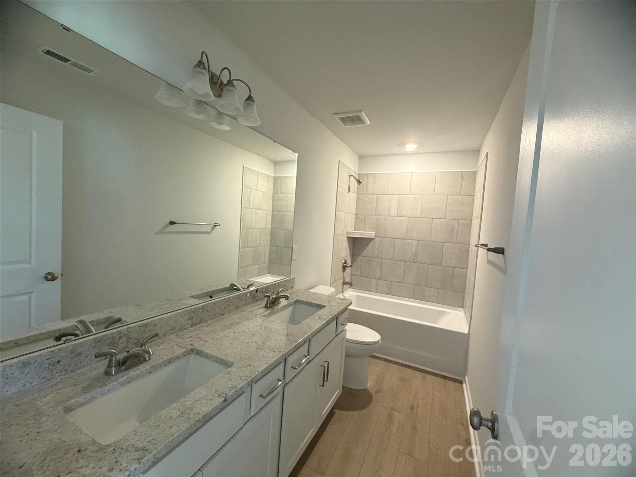 Full bathroom with double sink upstairs hallway with shower/tub combination - 4021 Juno Drive, Charlotte
