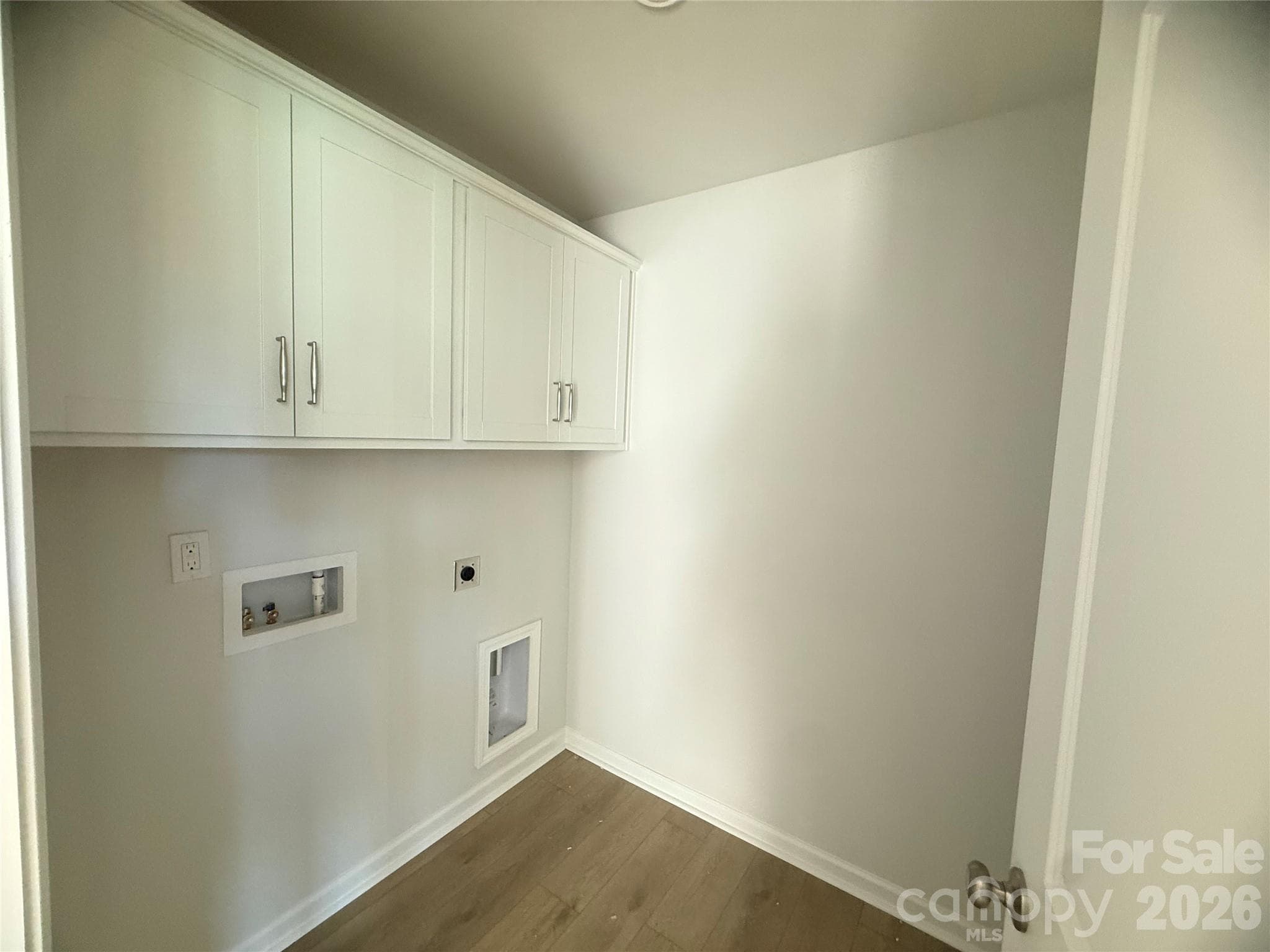 Laundry room upstairs with built-in cabinets - 4021 Juno Drive, Charlotte