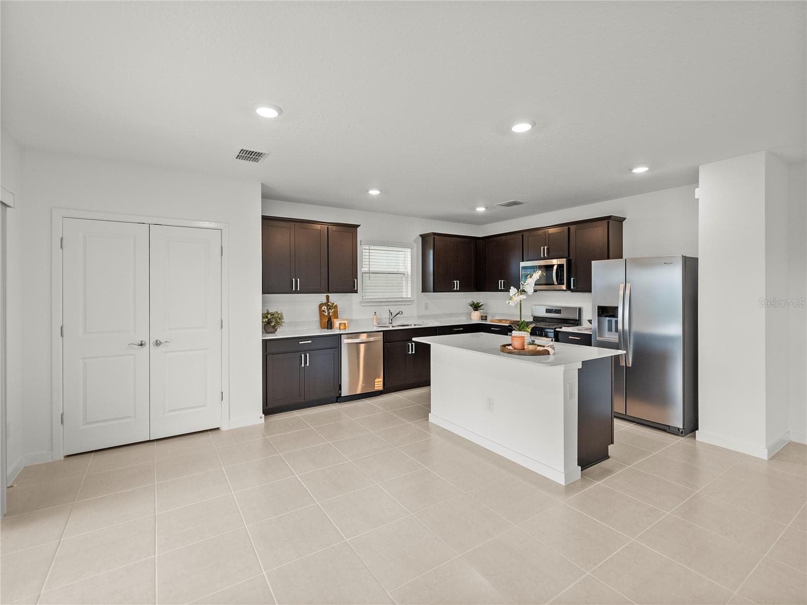 Upgraded Kitchen with Wood Cabinets, Upgraded Stainless Steel Appliance Package, All New Hardware & Quartz Countertops - 1076 KISTNA DR, ZEPHYRHILLS