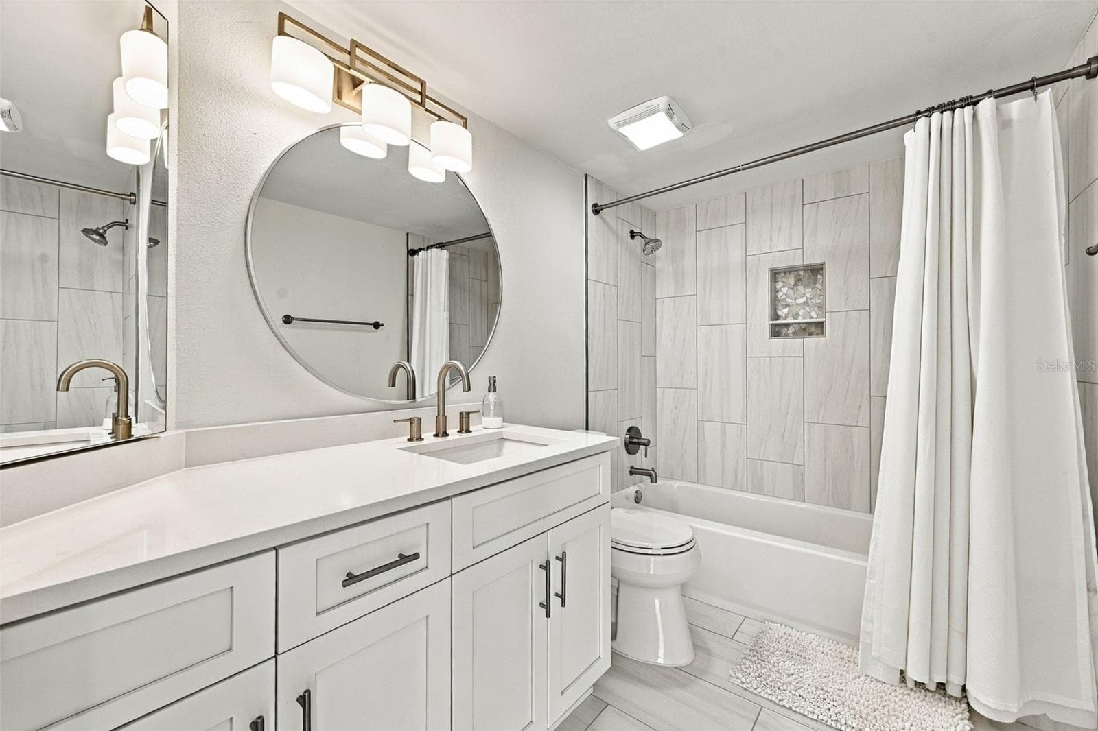 The third bath serves as a hall bath for guests and is just outside the third bedroom for convenience. - 5700 ESCONDIDA BLVD S #401, ST PETERSBURG