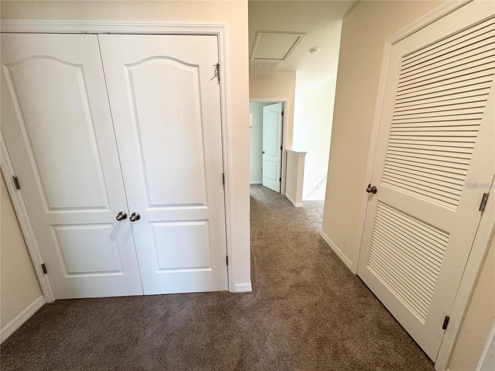 View of second story, enclosed laundry room and primary bedroom entrance. - 2353 PENGUIN BLVD, DAVENPORT
