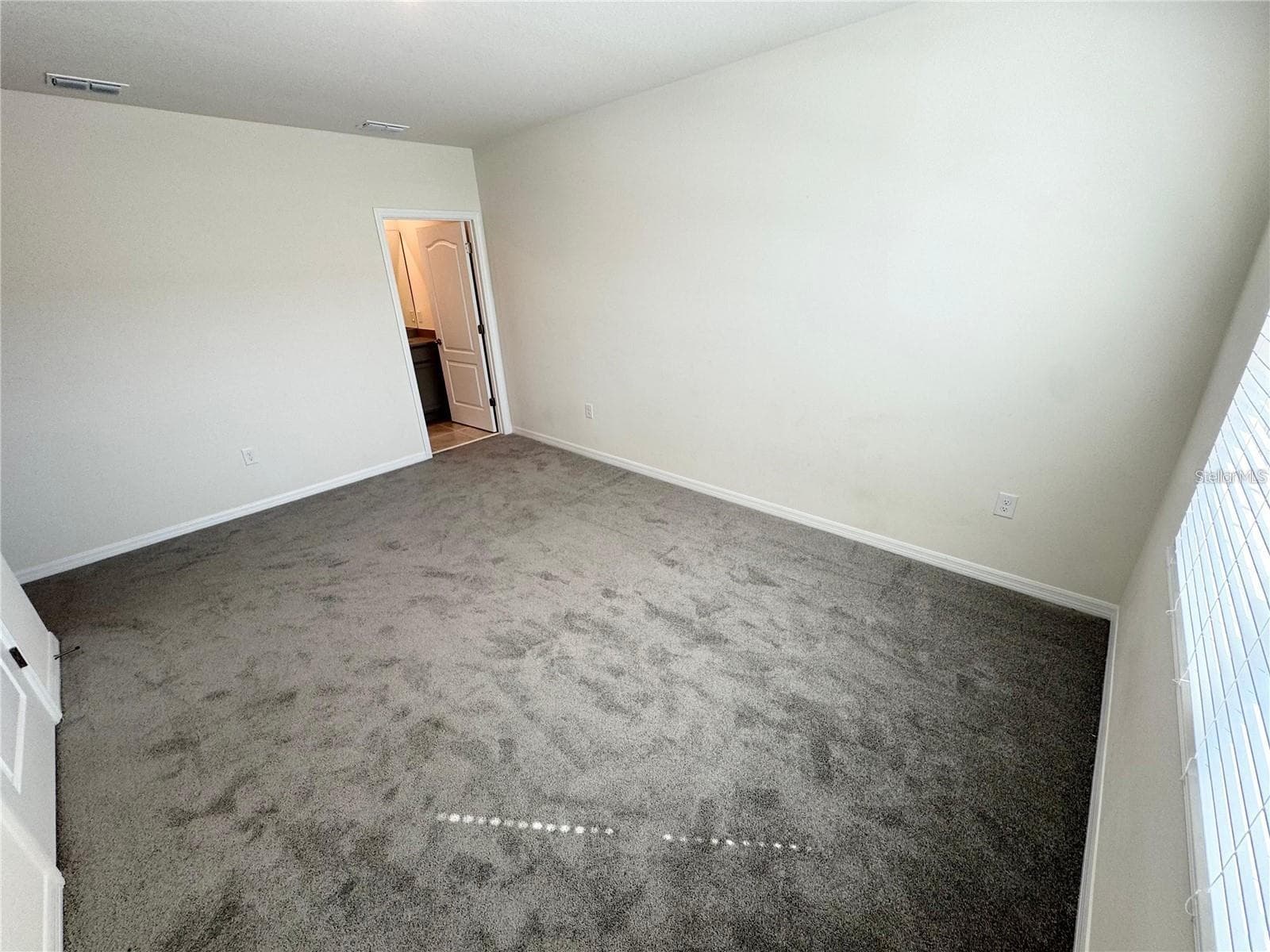 View of primary bedroom toward primary bathroom. - 2353 PENGUIN BLVD, DAVENPORT