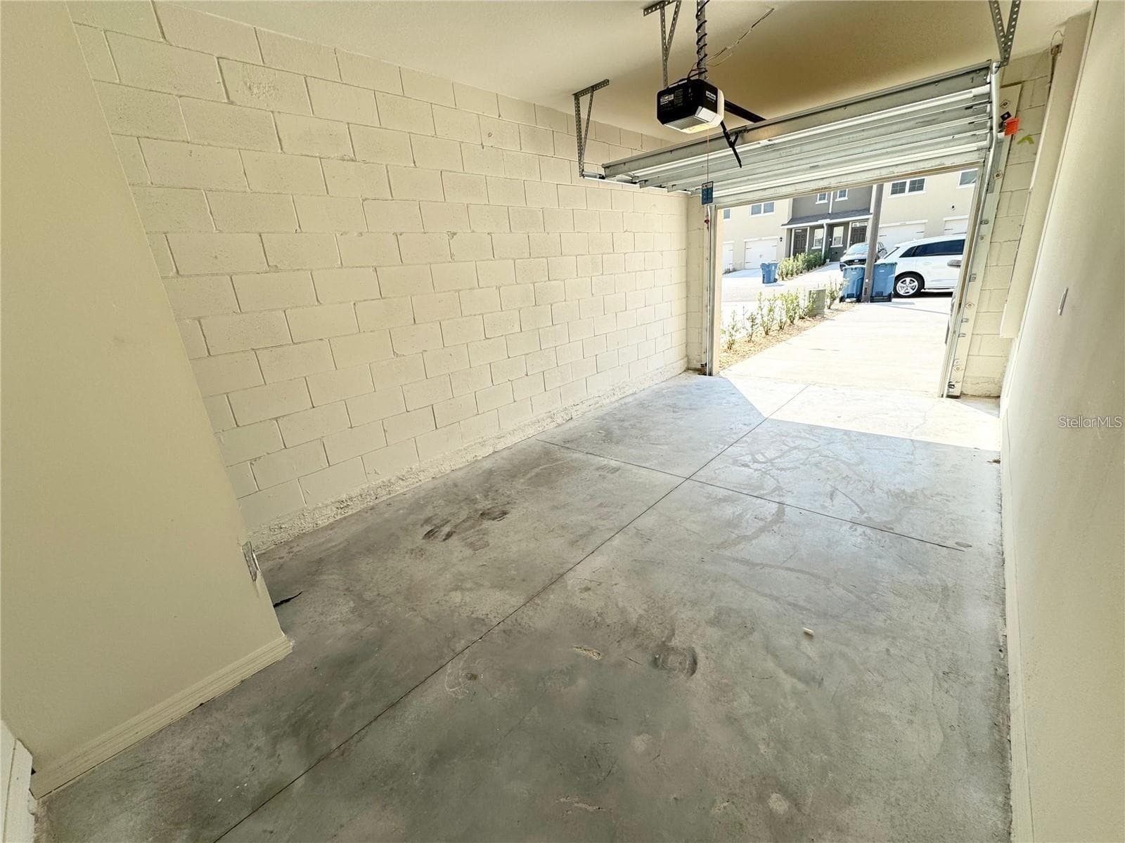 View from exit/entrance door, interior of garage toward parking area. - 2353 PENGUIN BLVD, DAVENPORT