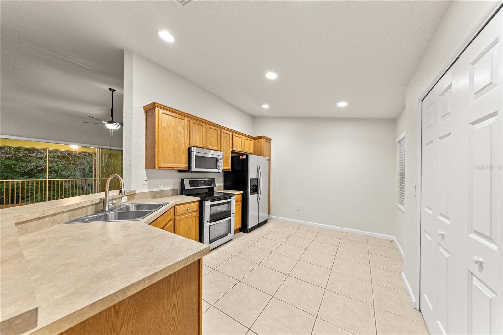 Large Kitchen with In-Unit laundry hookups and overlooks Living Room and features a double oven! - 4540 SW 52ND CIR #104, OCALA