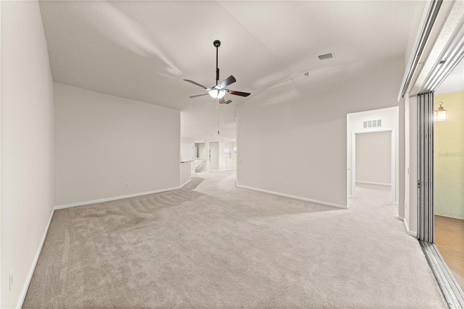 Living Room with telescoping sliding doors to screened in back patio - 4540 SW 52ND CIR #104, OCALA