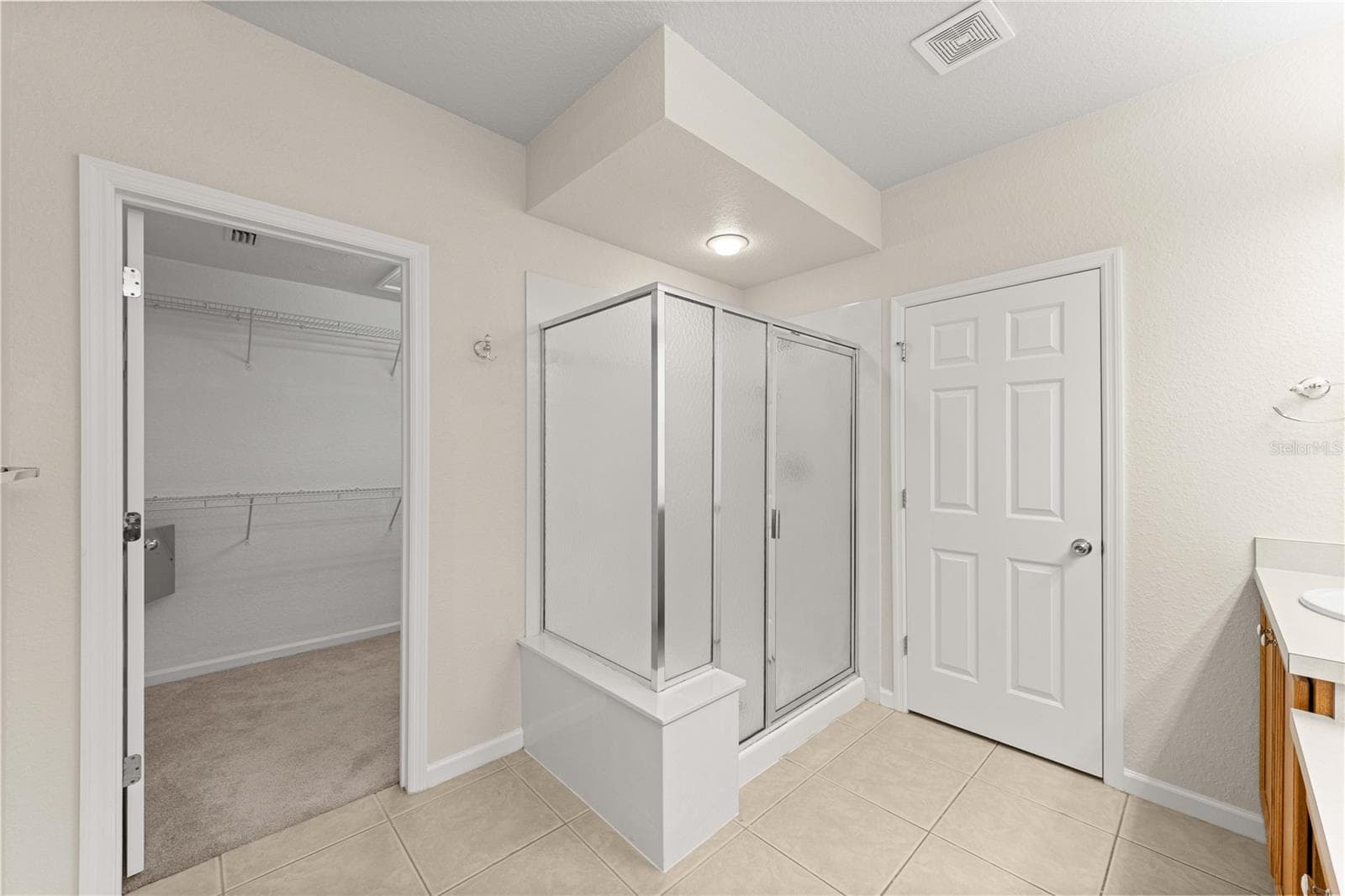 Primary en suite bathroom with walk in shower - 4540 SW 52ND CIR #104, OCALA