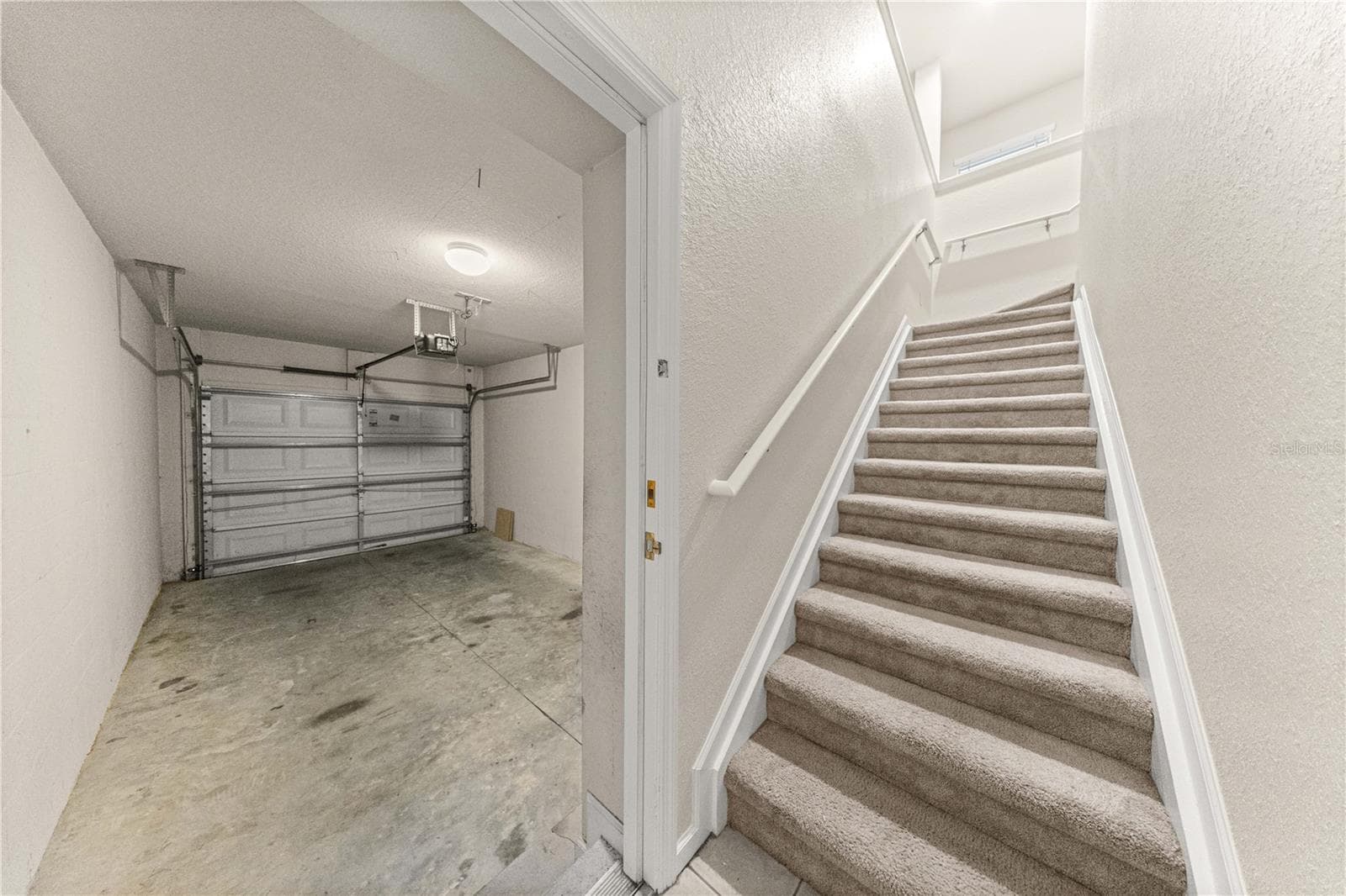 Entryway- 1 car garage to left and stairway to living area - 4540 SW 52ND CIR #104, OCALA