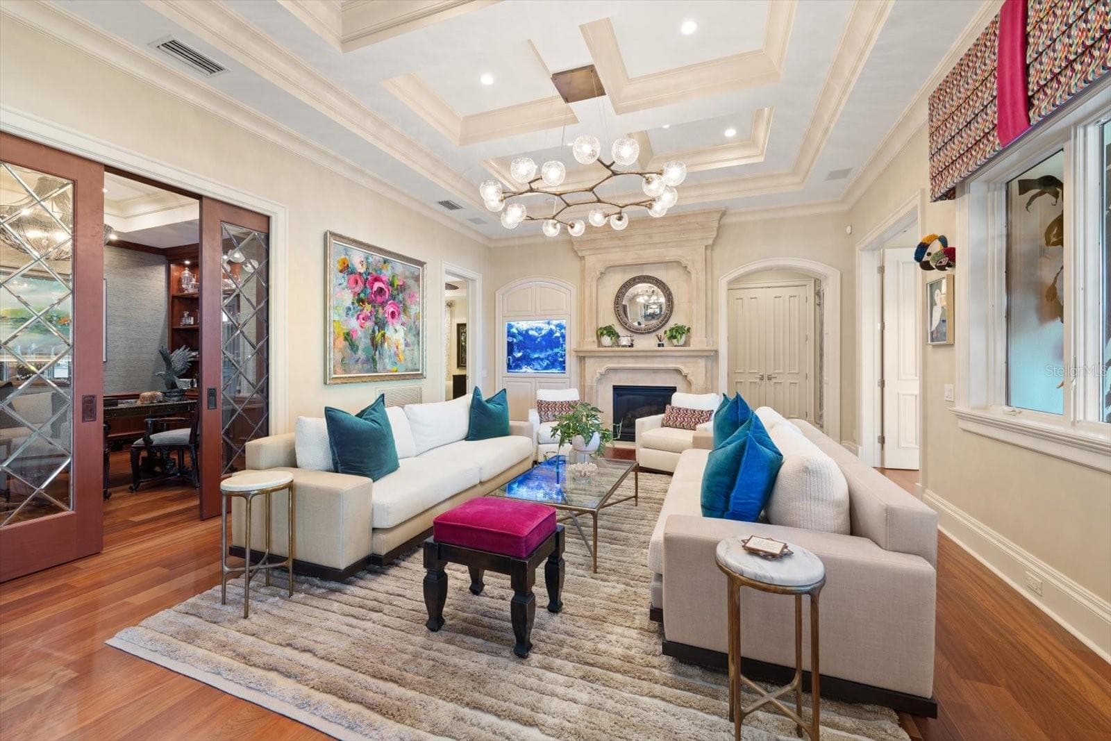 A gas fireplace with a precast stone mantel and a built-in saltwater aquarium in the formal living room - 2056 COVE TRCE, PALM HARBOR