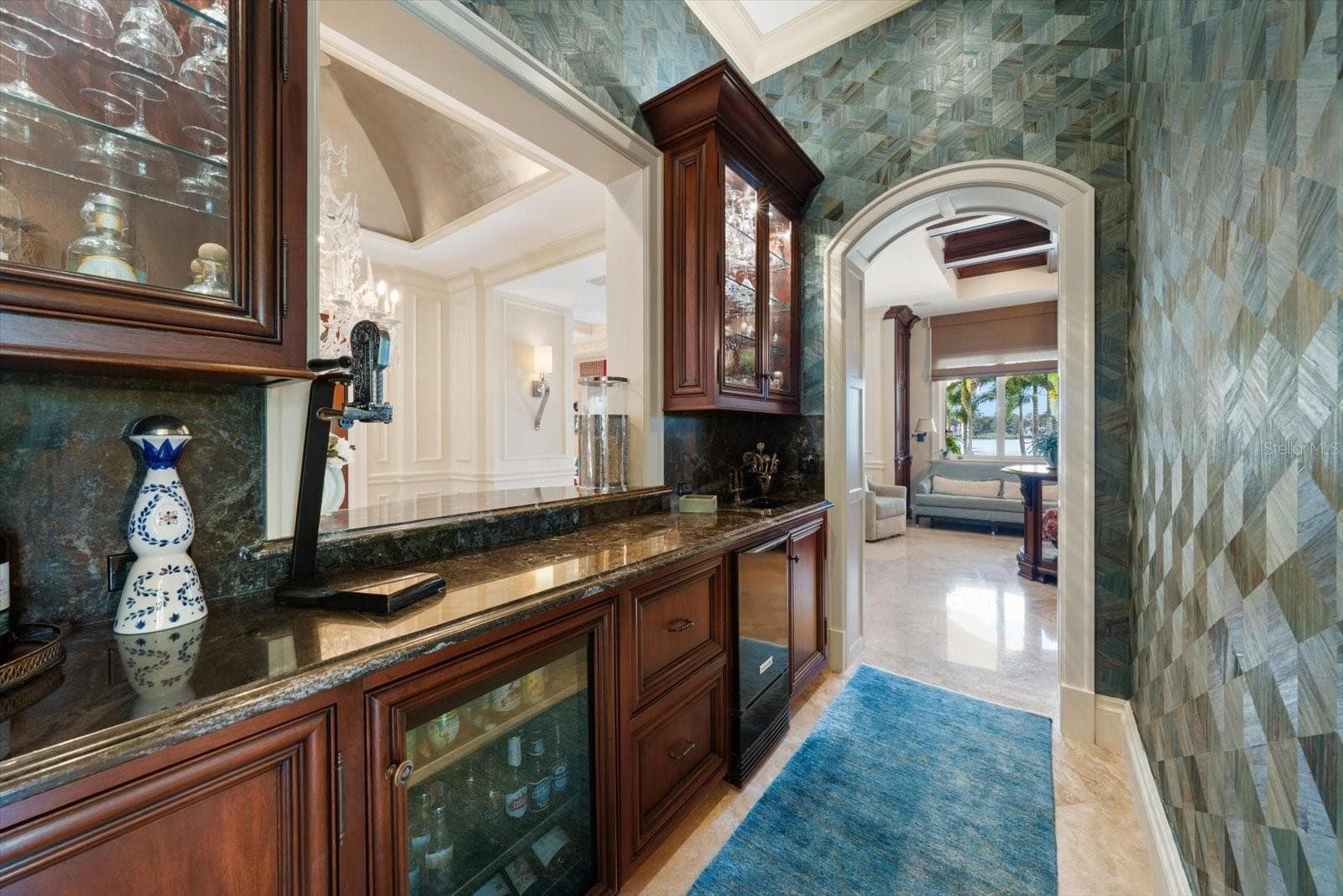 Beautifully appointed wet bar with ice maker, beverage fridge and beautifully displayed stemware - 2056 COVE TRCE, PALM HARBOR
