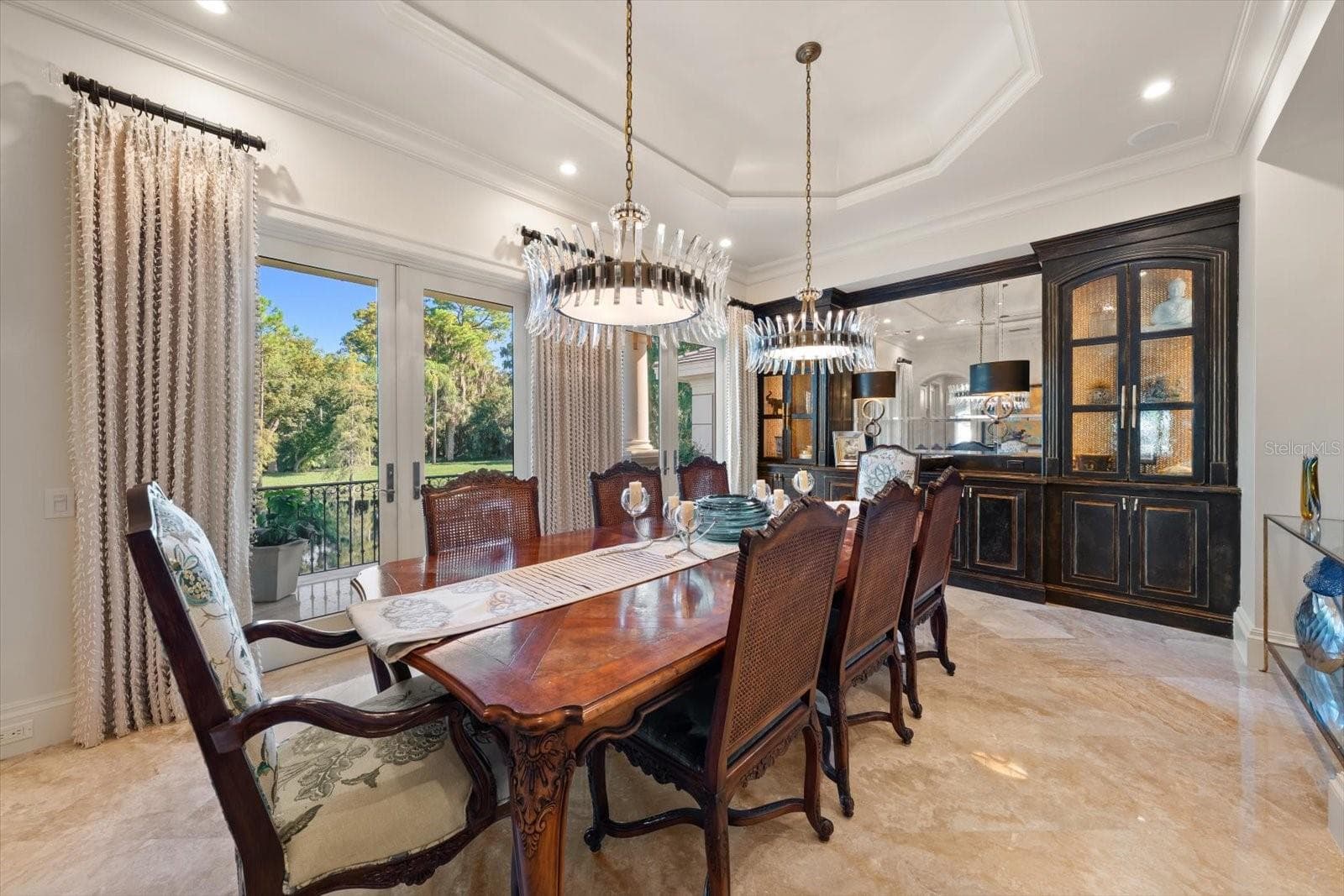 A formal dining room overlooking the lake and natural surroundings - 2056 COVE TRCE, PALM HARBOR