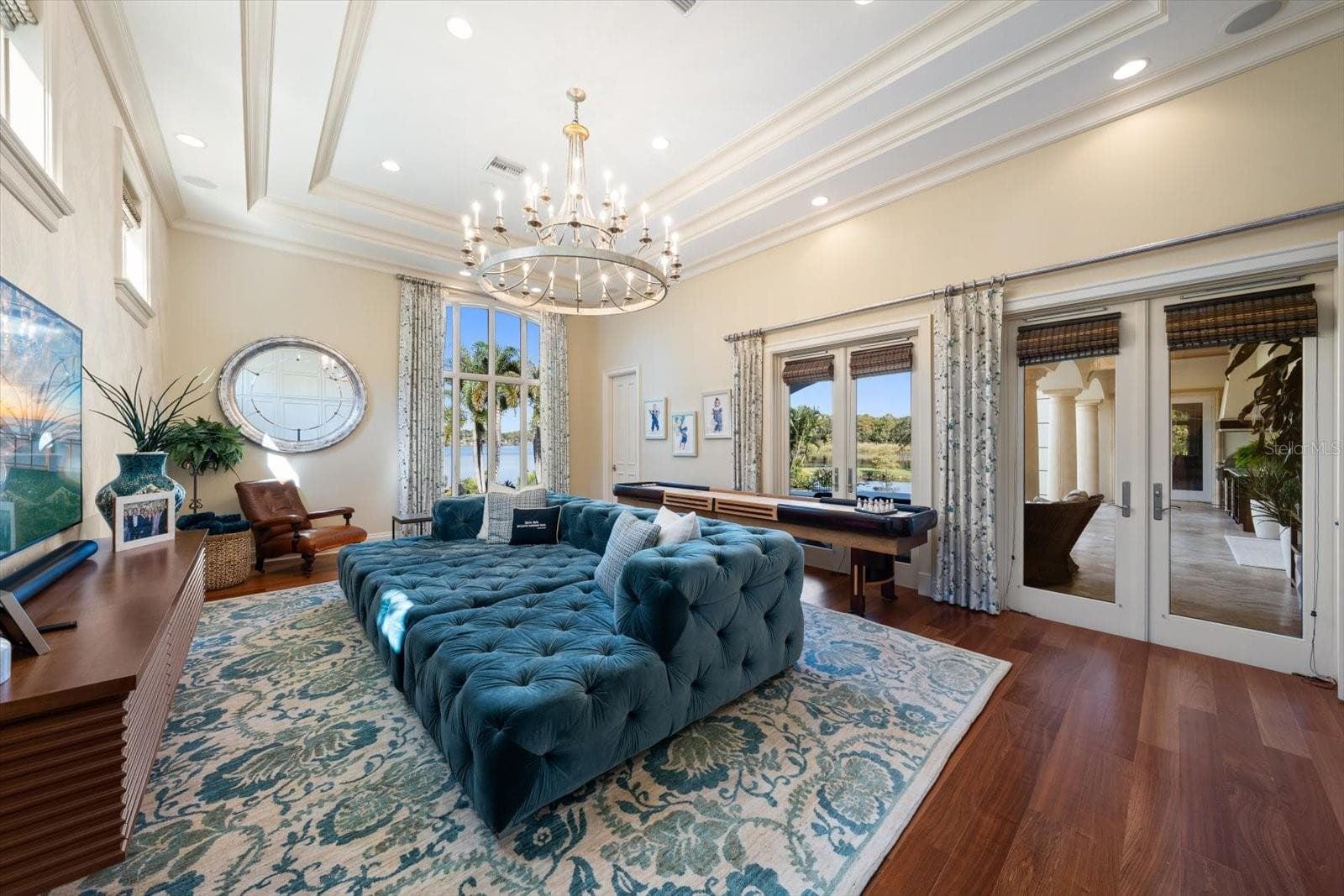 Jaw-Dropping Family Room with Double French Doors leading outside & Built in Murphy Bed - 2056 COVE TRCE, PALM HARBOR
