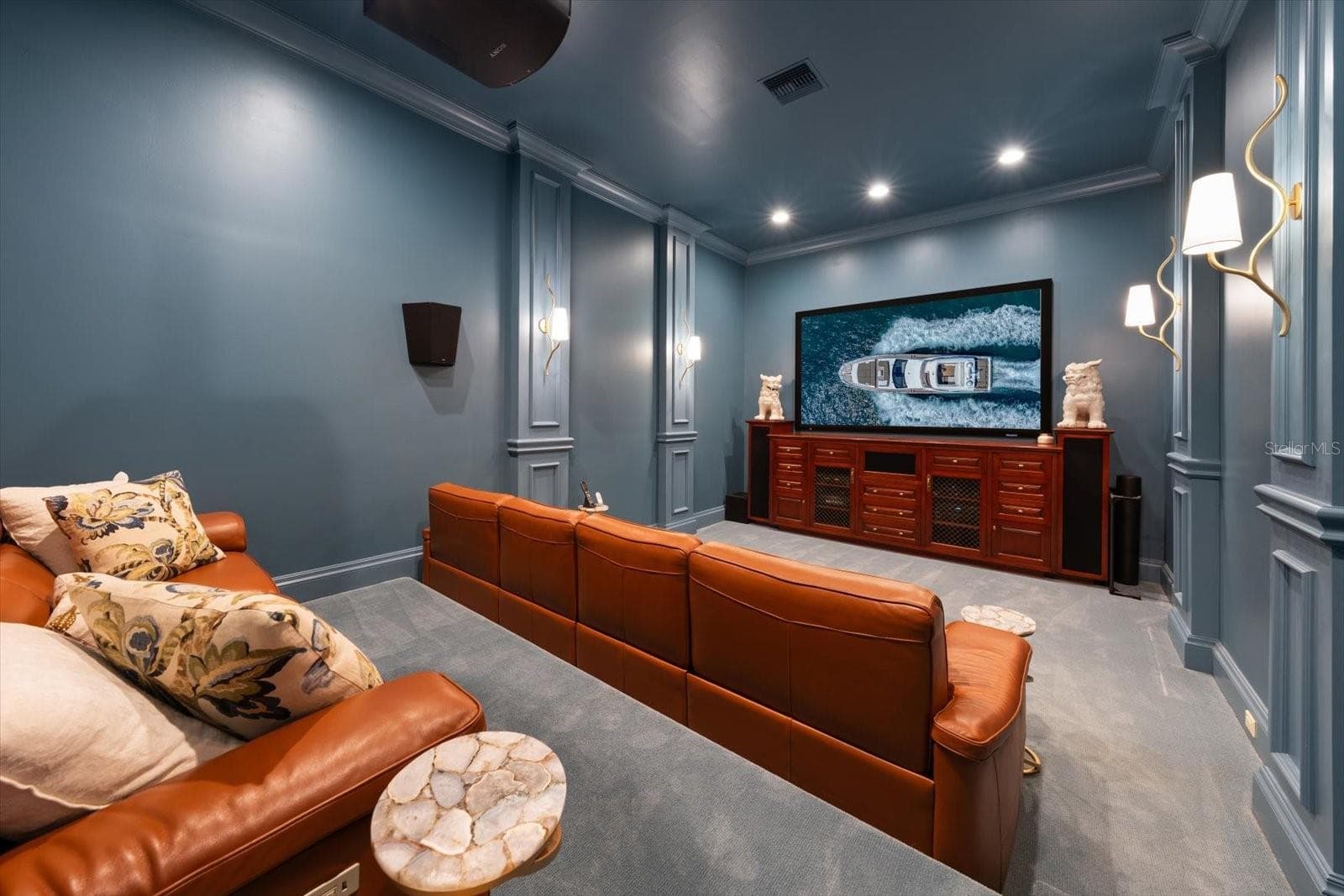 Media Room with a built-in projection screen and sound-blocking insulation with stadium style seating - 2056 COVE TRCE, PALM HARBOR