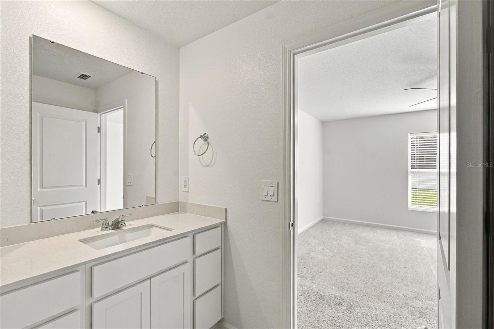 The private owner’s suite is tucked away at the back of the home and features an en-suite bathroom with dual sinks, a walk-in shower, and a generous walk-in closet. - 2007 FORAGE DR, KISSIMMEE
