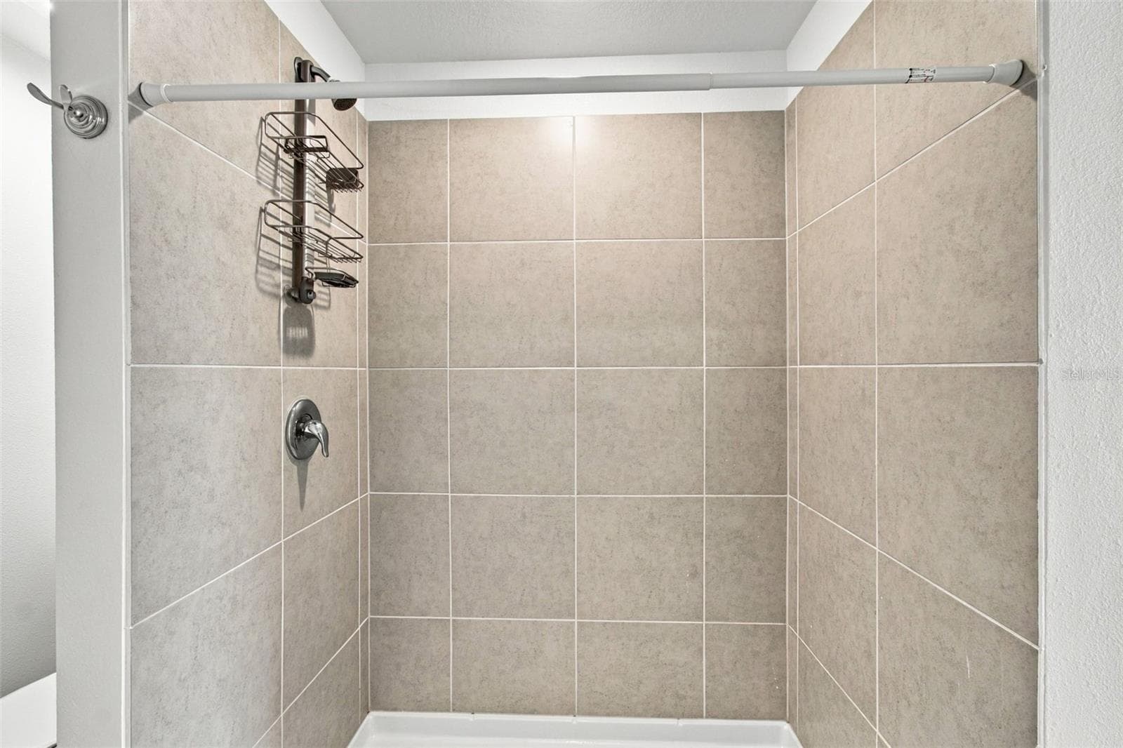 The private owner’s suite is tucked away at the back of the home and features an en-suite bathroom with dual sinks, a walk-in shower, and a generous walk-in closet. - 2007 FORAGE DR, KISSIMMEE