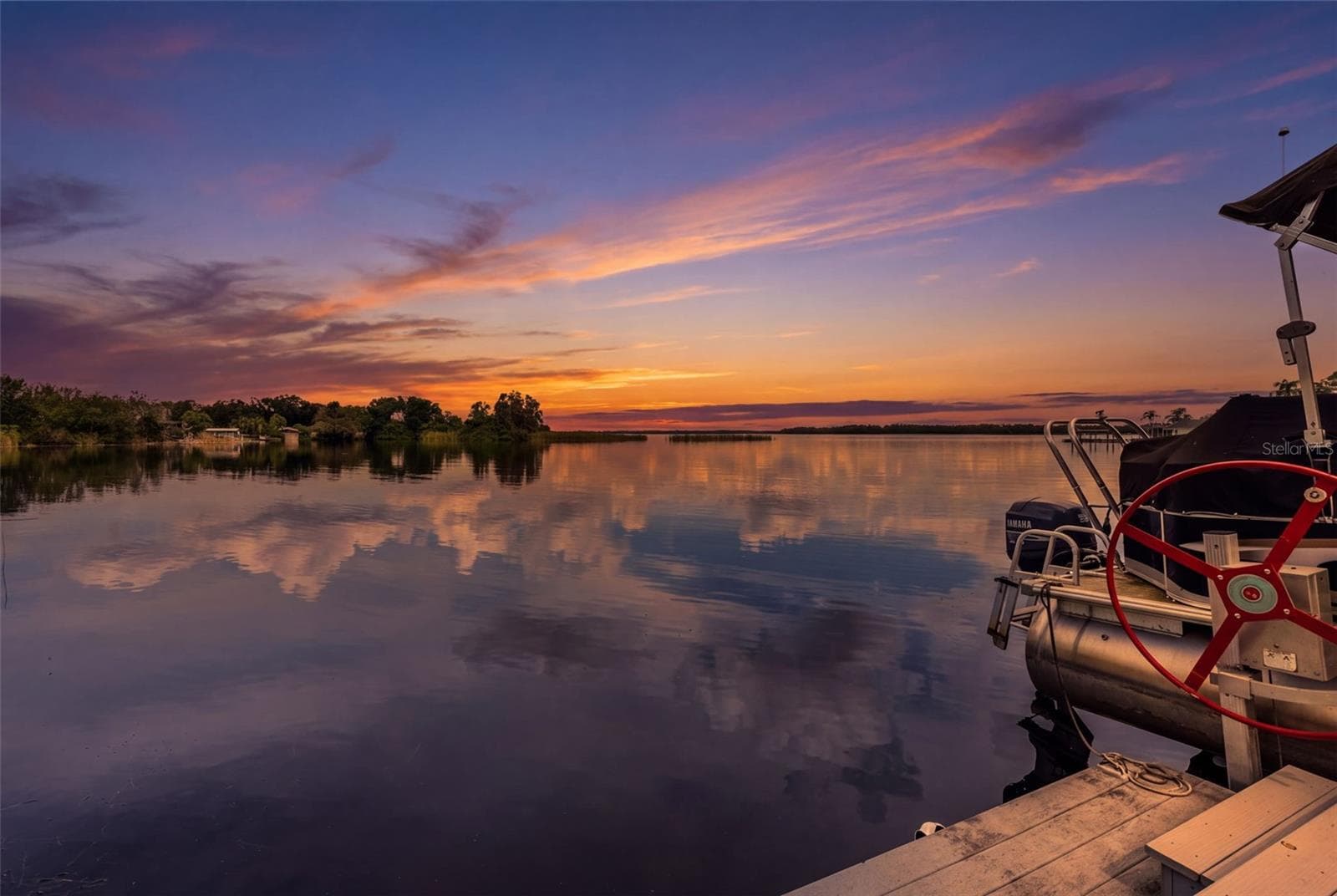 This is why people fall in love with waterfront living! Enjoy expansive water views, beautiful sunrise reflections, and the convenience of a private dock. Whether you're heading out on the boat or simply enjoying the evening, the waterfront lifestyle takes center stage. - 13 FRESHWATER, PALM HARBOR