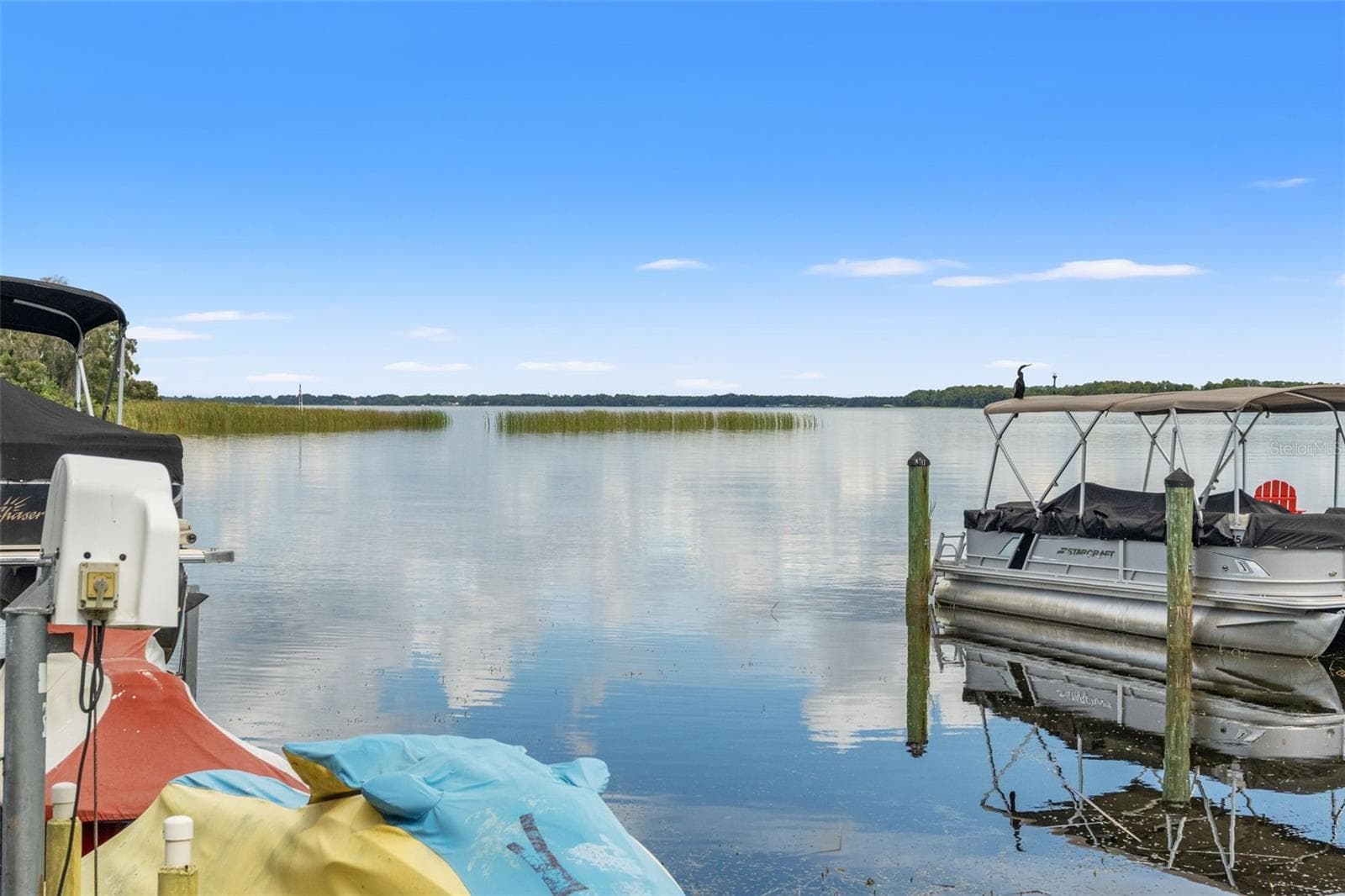 Wide-open water, peaceful surroundings, and beautiful Florida skies. Enjoy expansive lake views from the dock, with natural shoreline vegetation and distant tree-lined banks creating a scenic backdrop. A wonderful setting for boating, fishing, or simply appreciating the waterfront. - 13 FRESHWATER, PALM HARBOR