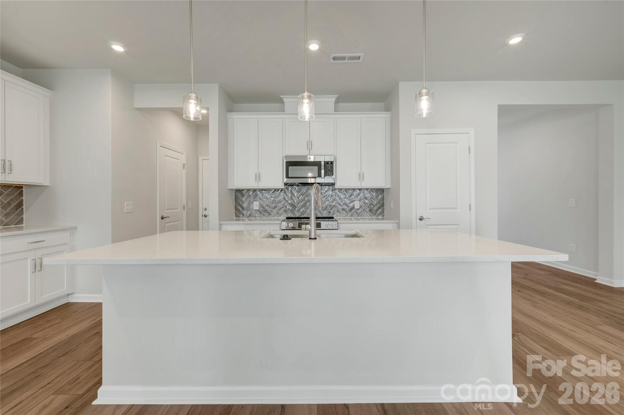 Kitchen with a large island featuring a large stainless steel single bowl sink - 709 Bowery Place, Cramerton
